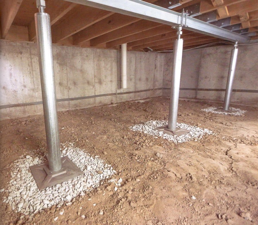 Insulated ductwork running through a construction area, silver and gray, supported by vertical posts.