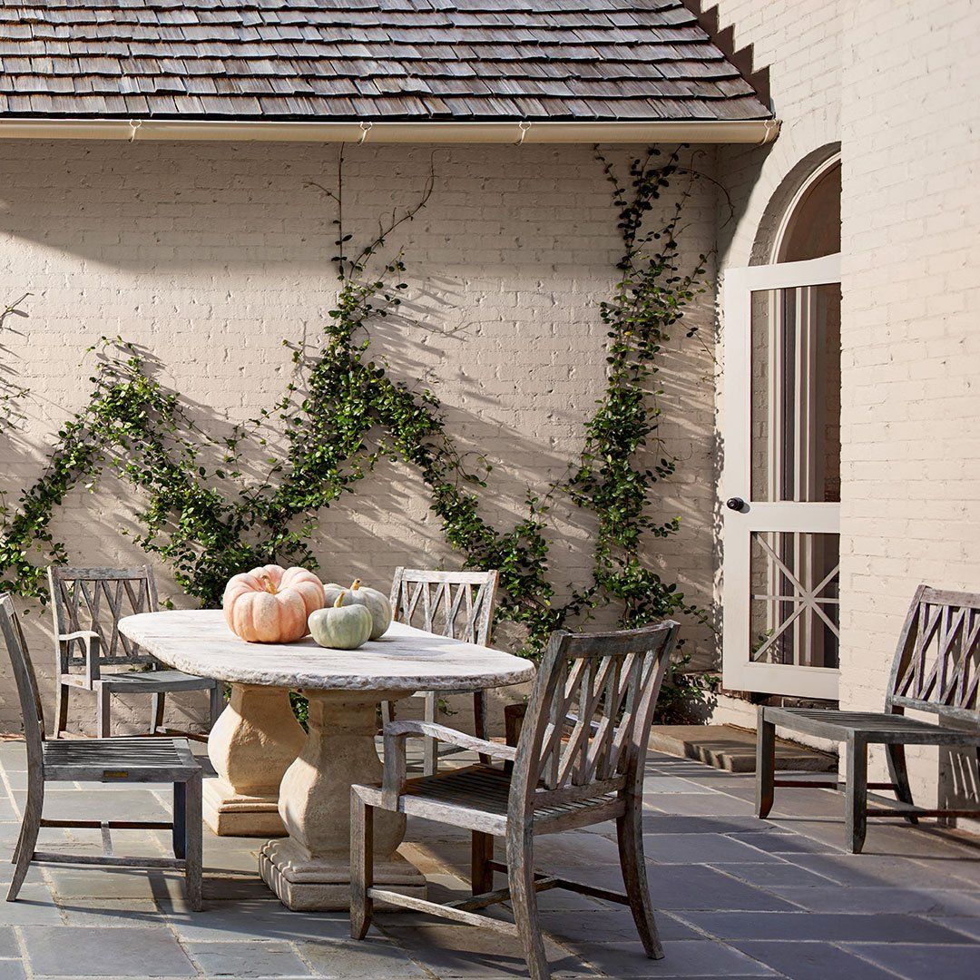 A table with pumpkins on it in front of a brick wall