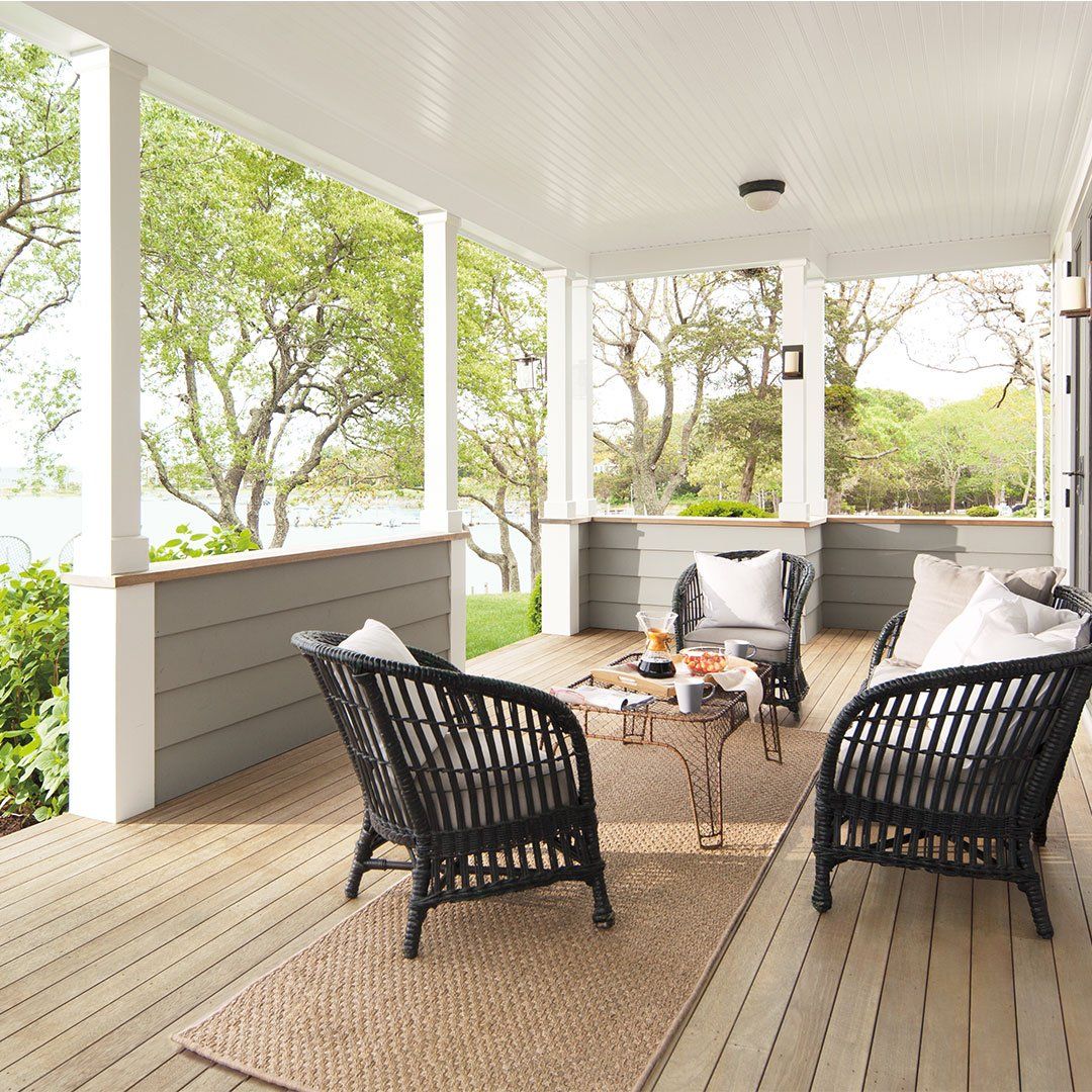A porch with wicker chairs and a coffee table