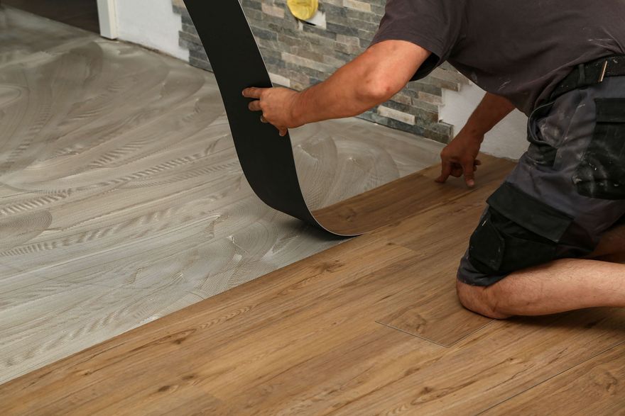 MOST POPULAR Person installing wood-look flooring beside existing gray floor pattern