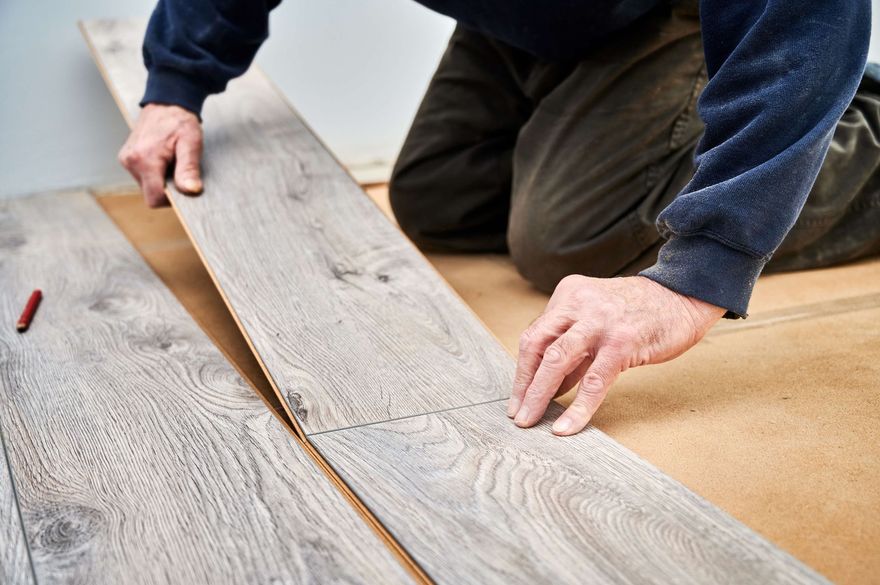 MOST POPULAR Hands aligning light wood planks on a floor during installation