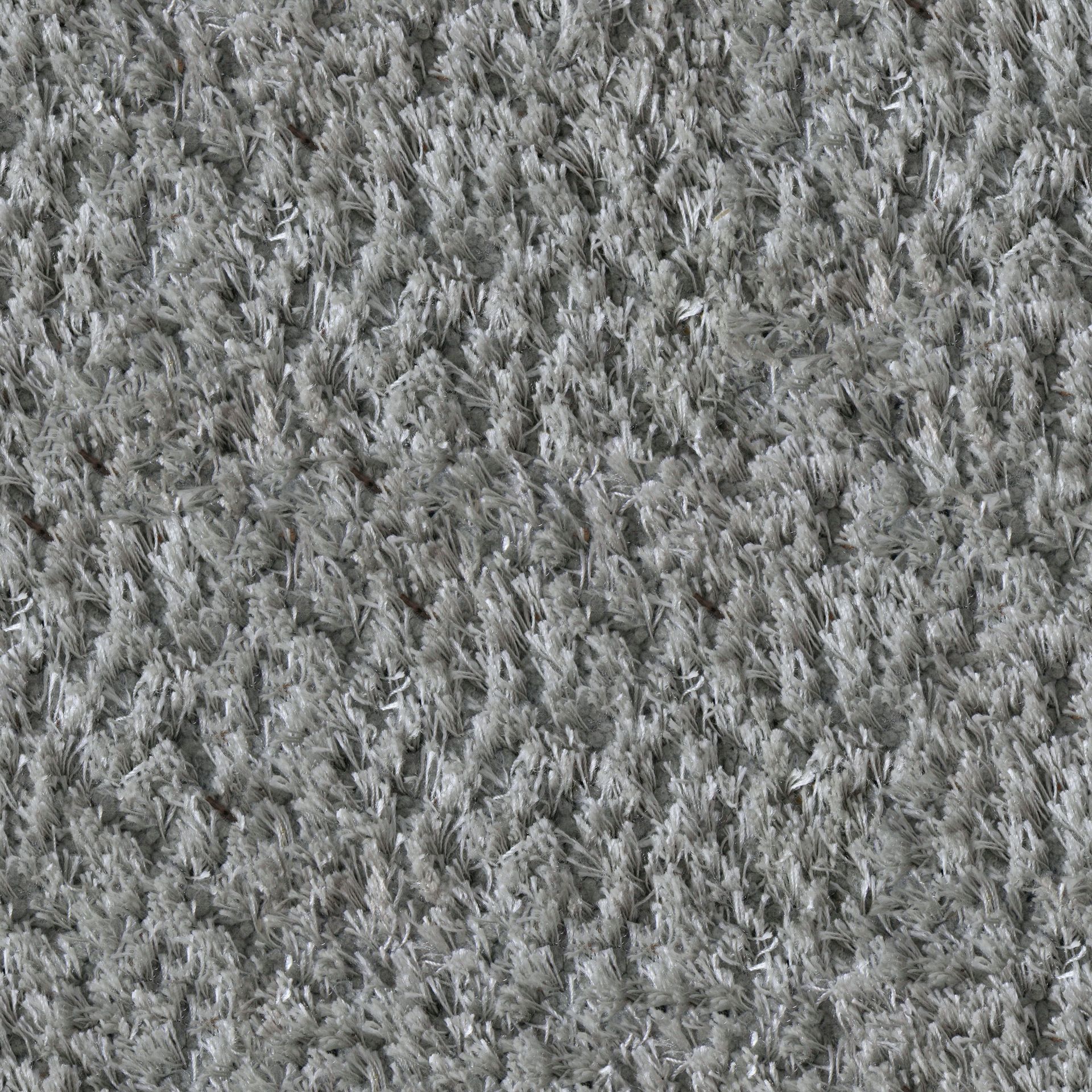 Close-up of gray textured carpet with a dense, shaggy pattern