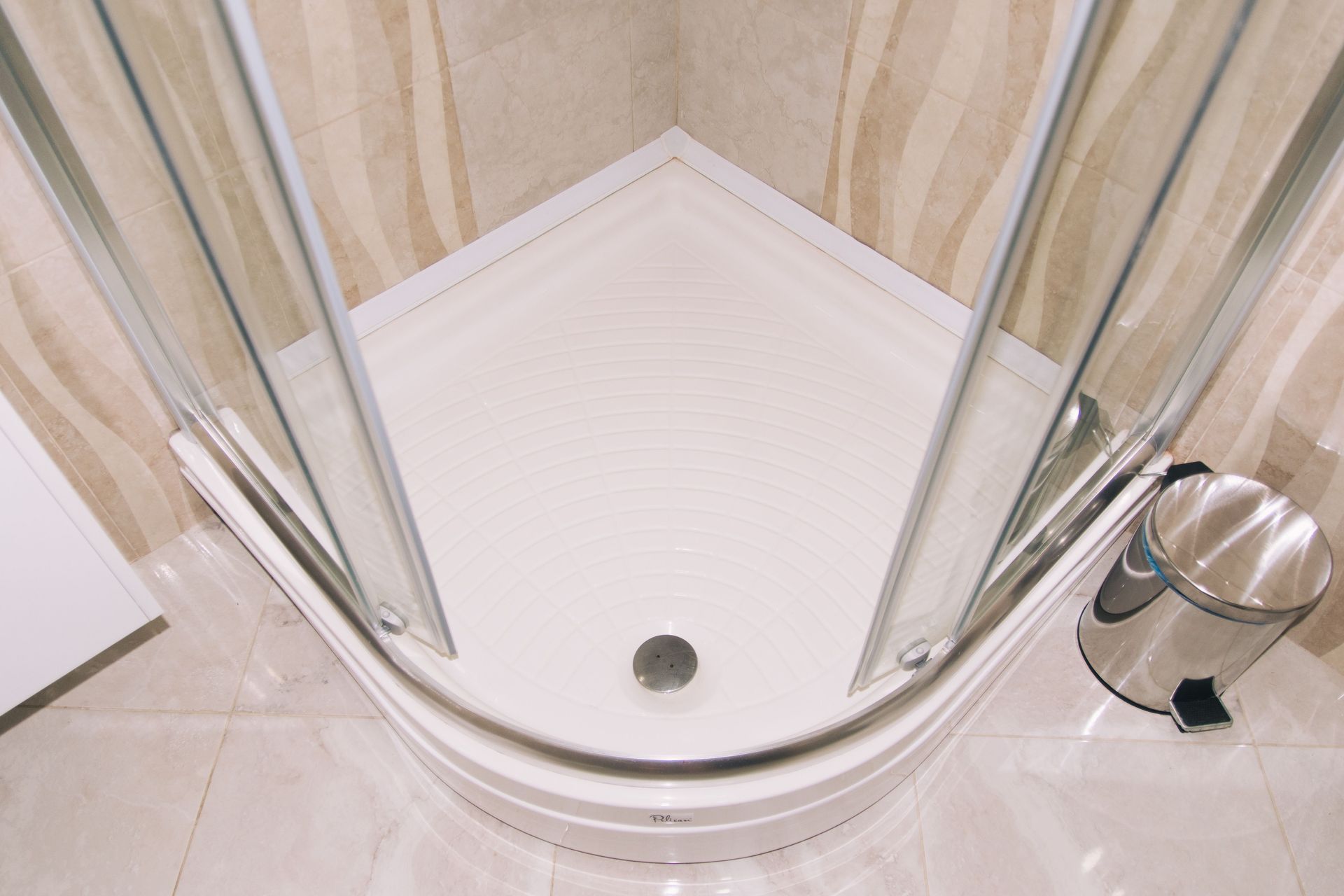 White bathtub and gray stone-look flooring in a modern bathroom