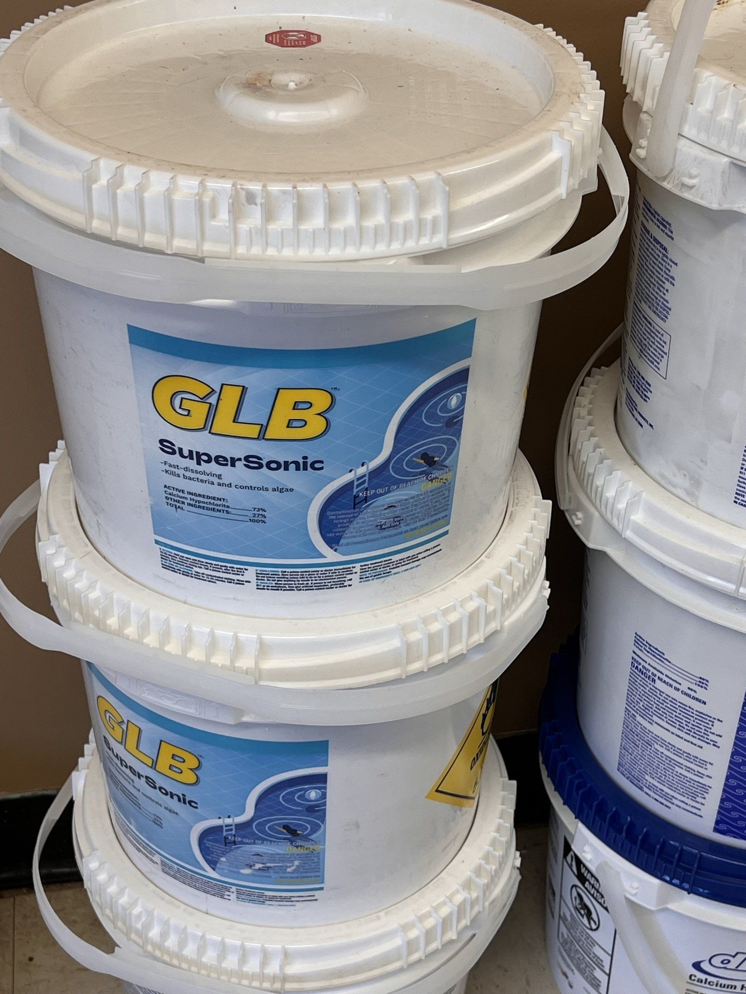 Stack of white buckets labeled 