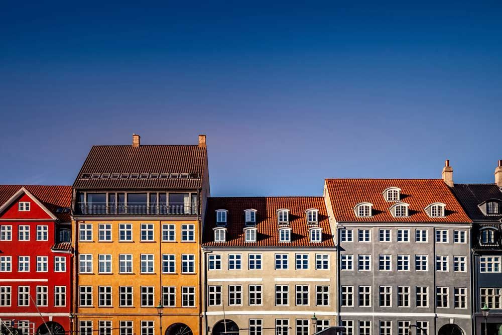 Row of colorful historic townhouses under a clear blue sky