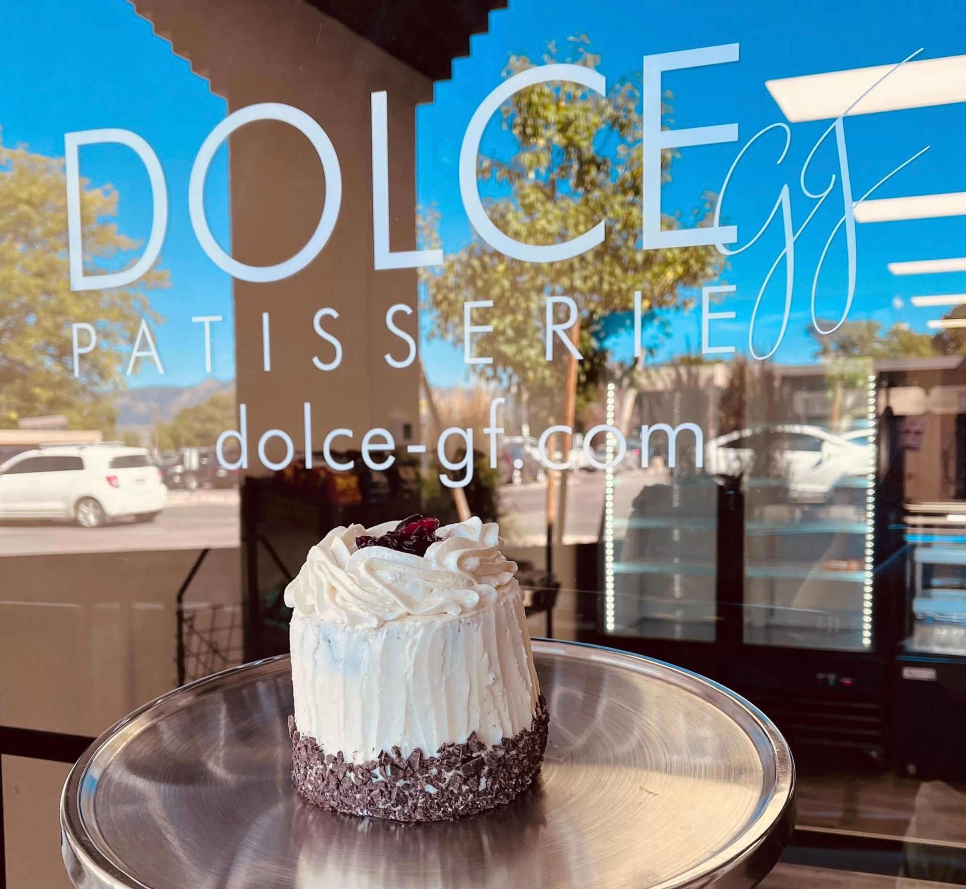 Dolce GF Patisserie storefront window signage and logo design with gluten-free cake displayed