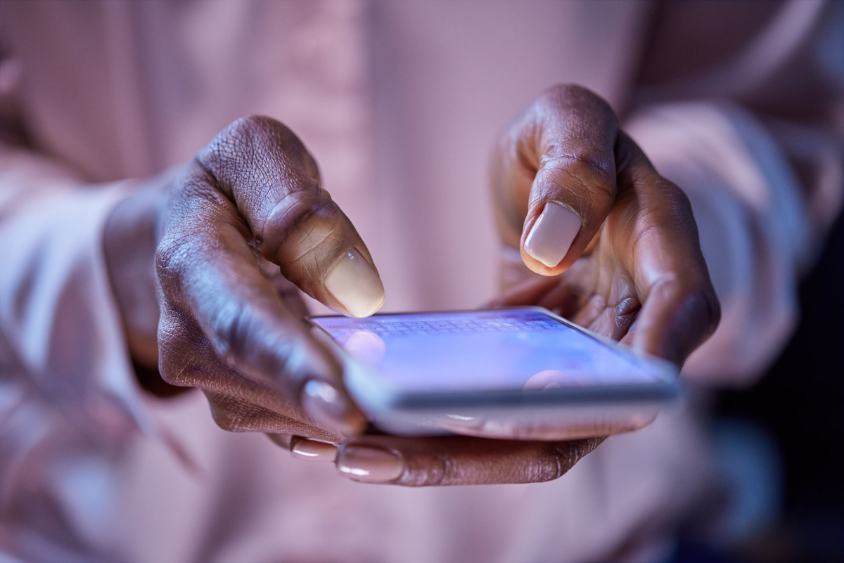 Person holding a smartphone, checking a security code