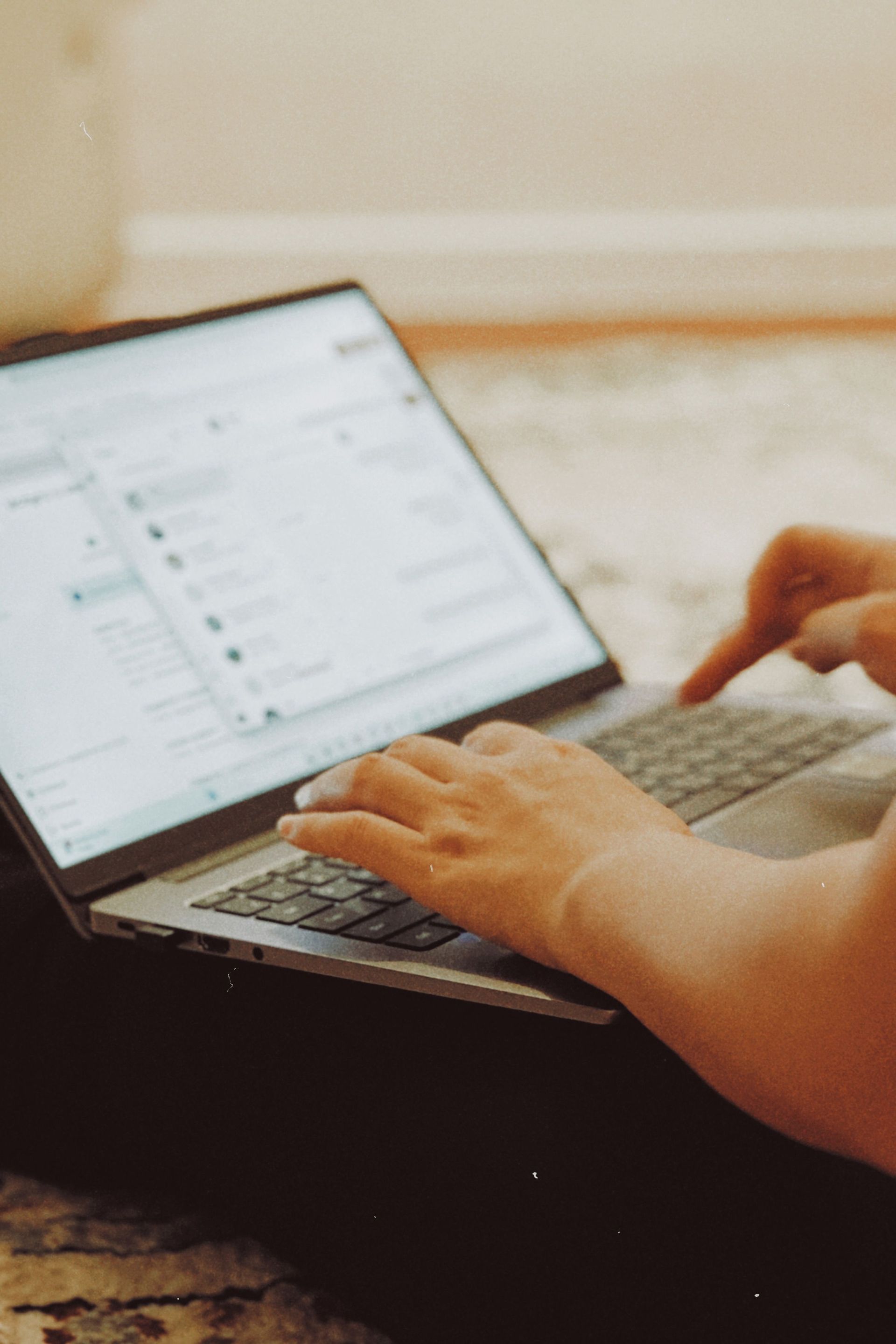 Small business owner reviewing an email campaign on a laptop
