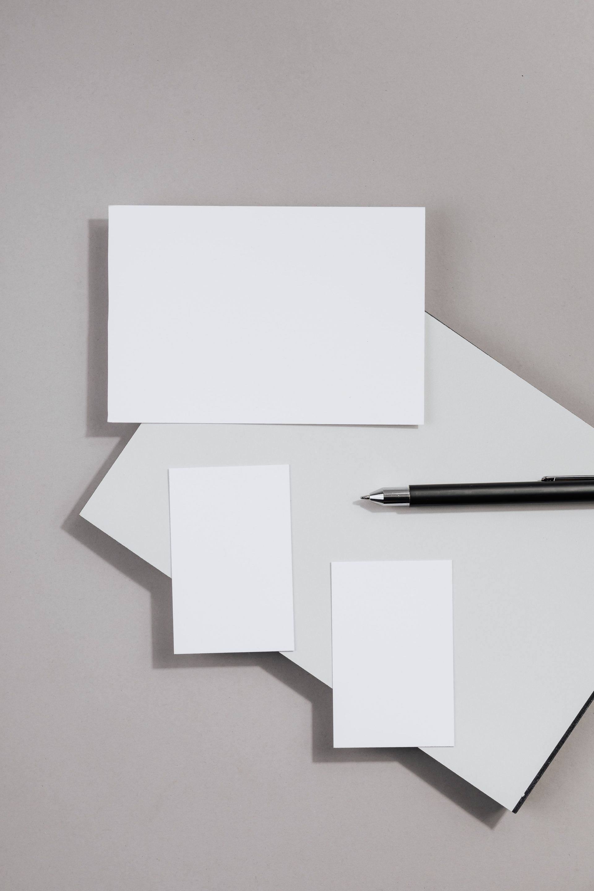White speech bubble cutouts on a gray background, with a pen beside them
