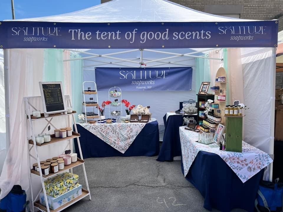 Soliture Soapworks vendor tent design with navy and white banner reading The Tent of Good Scents