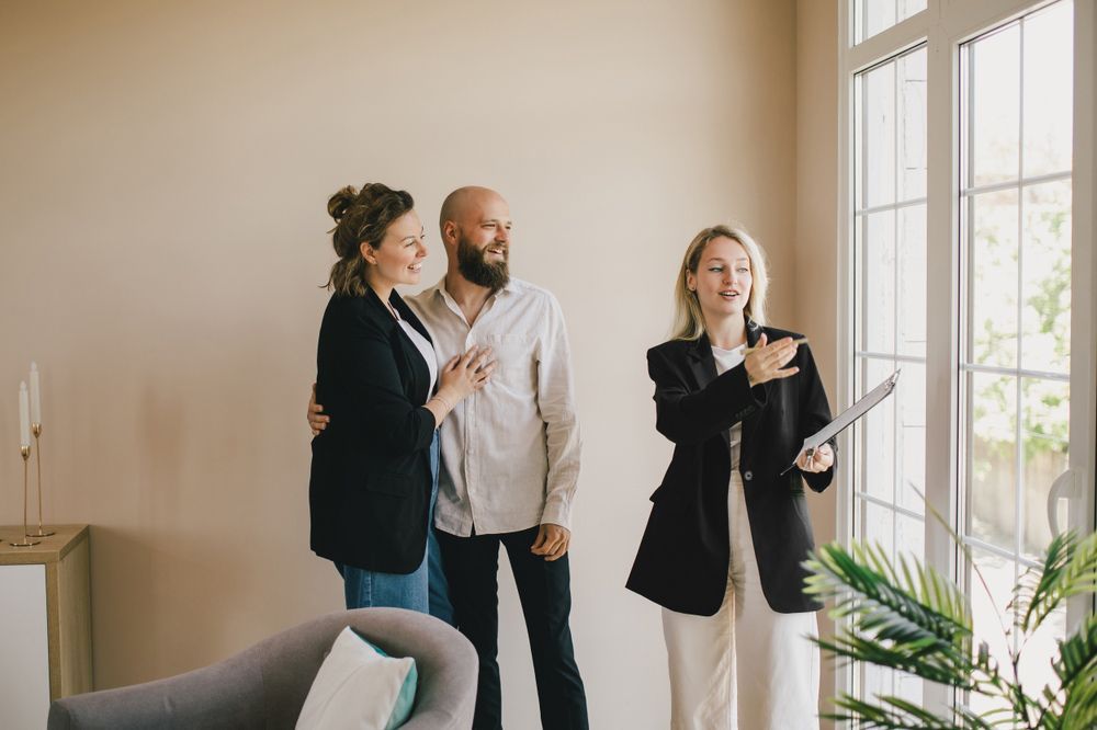 A Man and A Woman Are Standing Next to Each Other in A Living Room — A M Conveyancing Pty Ltd In Tweed Heads, NSW