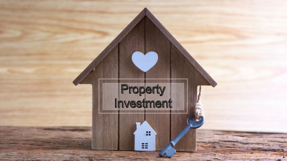 A Wooden House with A Heart and A Key on A Wooden Table — A M Conveyancing Pty Ltd In Tweed Heads, NSW