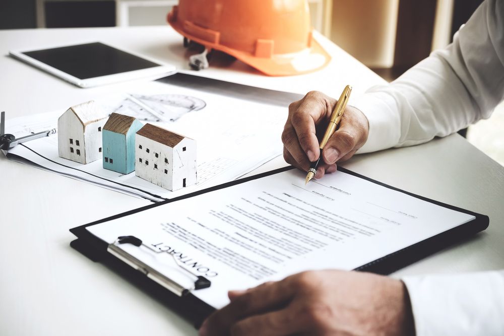 A Person Is Writing on A Clipboard with A Pen— A M Conveyancing Pty Ltd In Northern Rivers, NSW