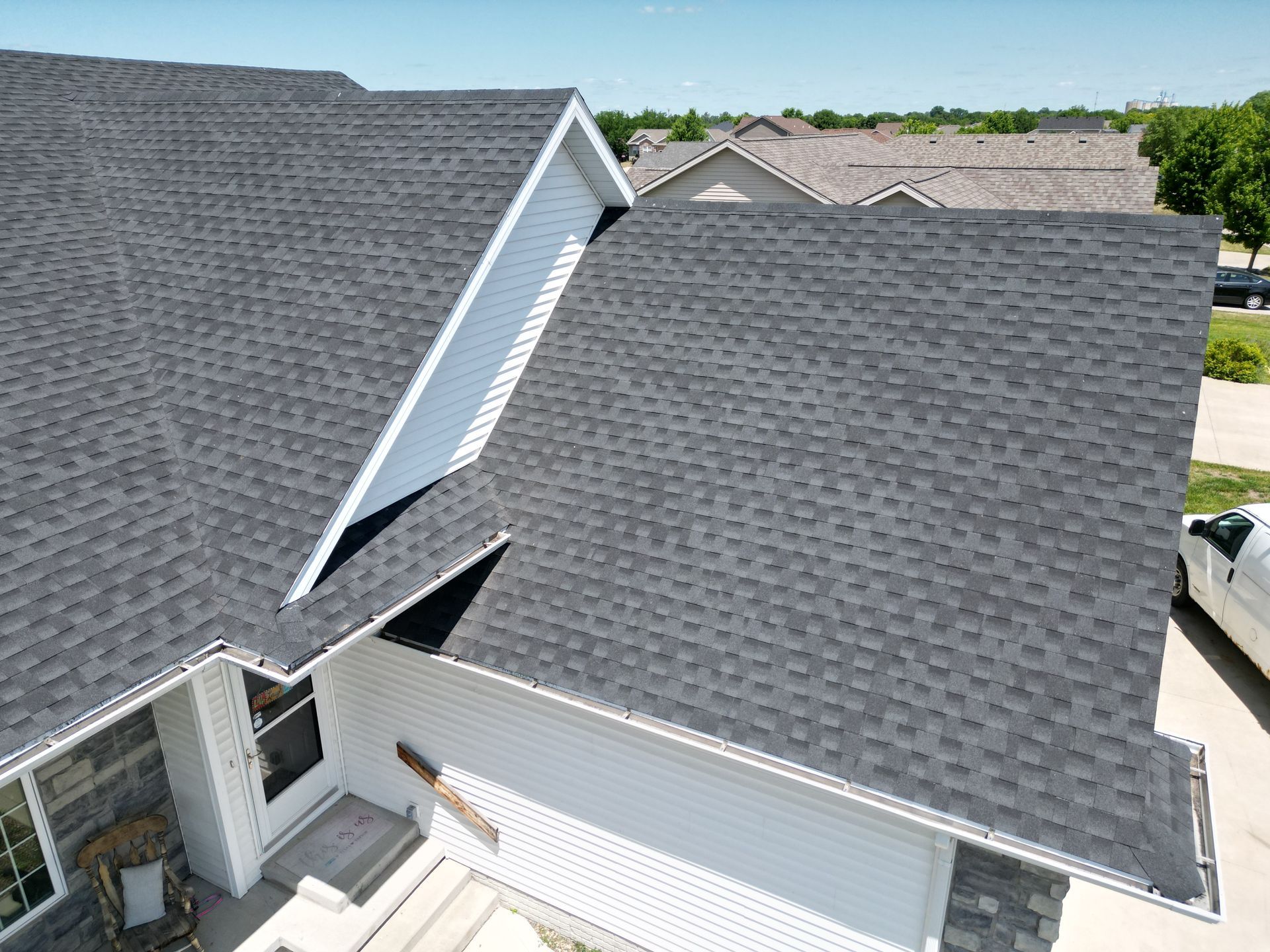 An aerial view of a house with a gray roof.