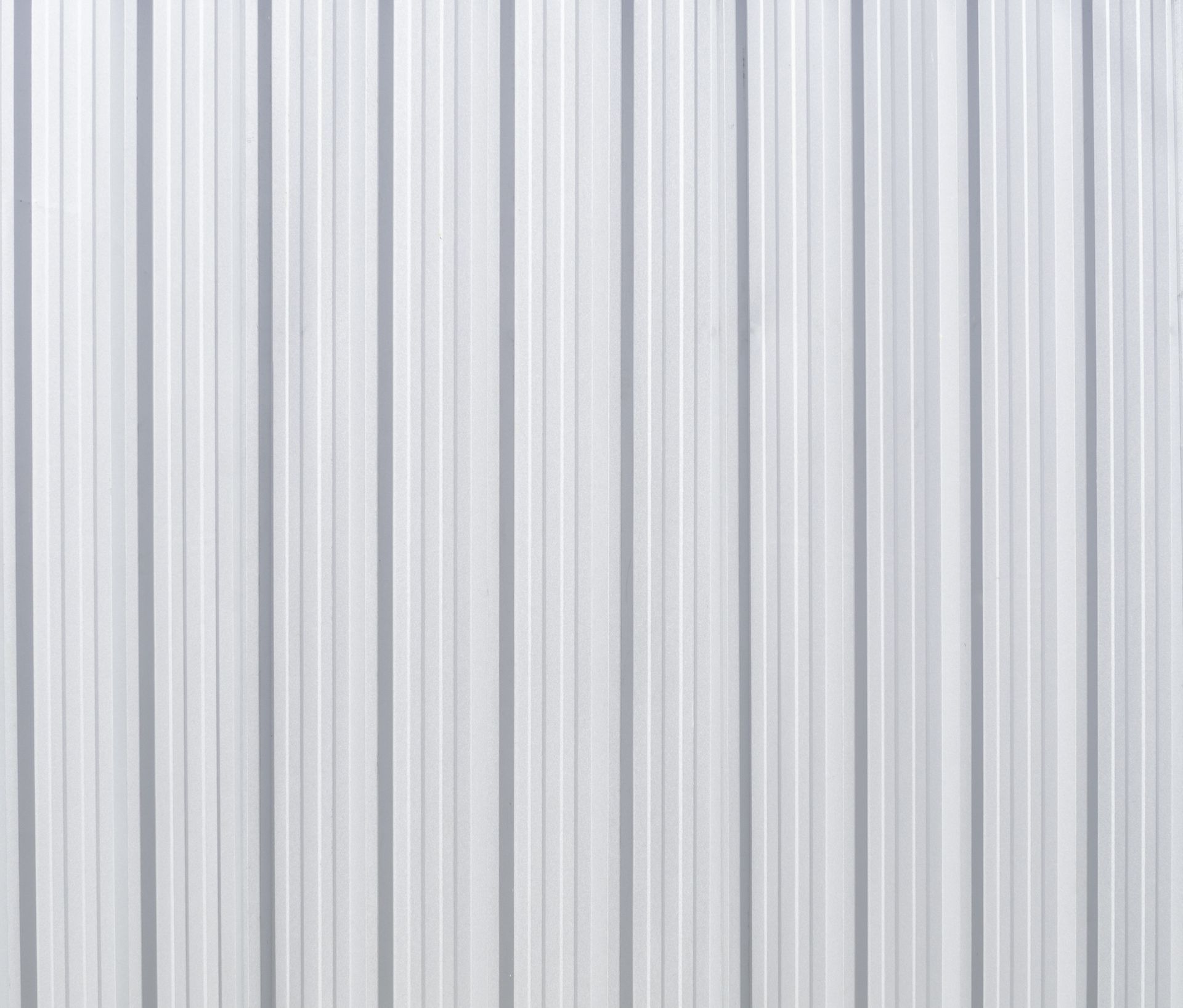 A close up of a white corrugated metal wall.
