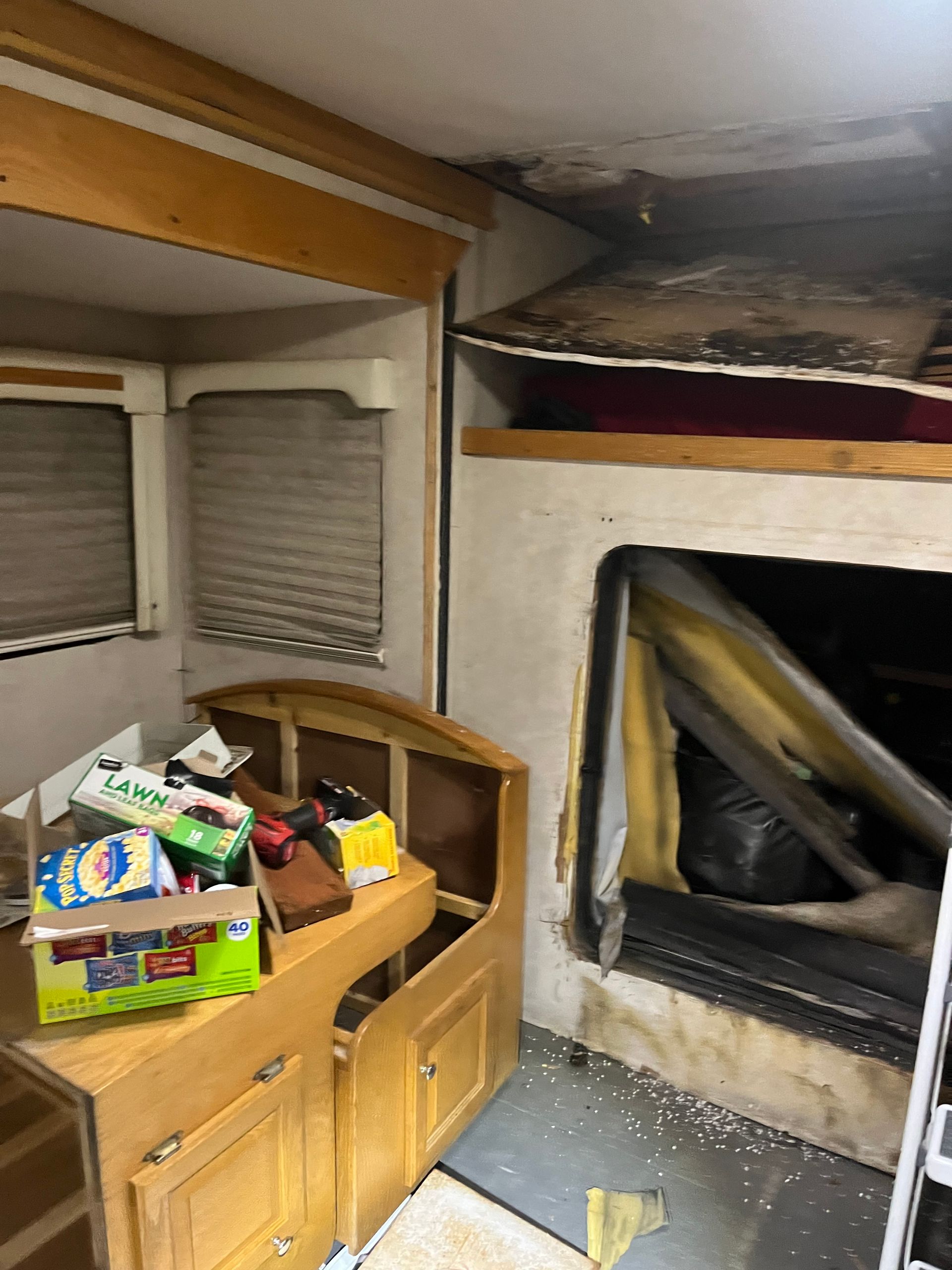Interior of a damaged RV with mold and debris visible.
