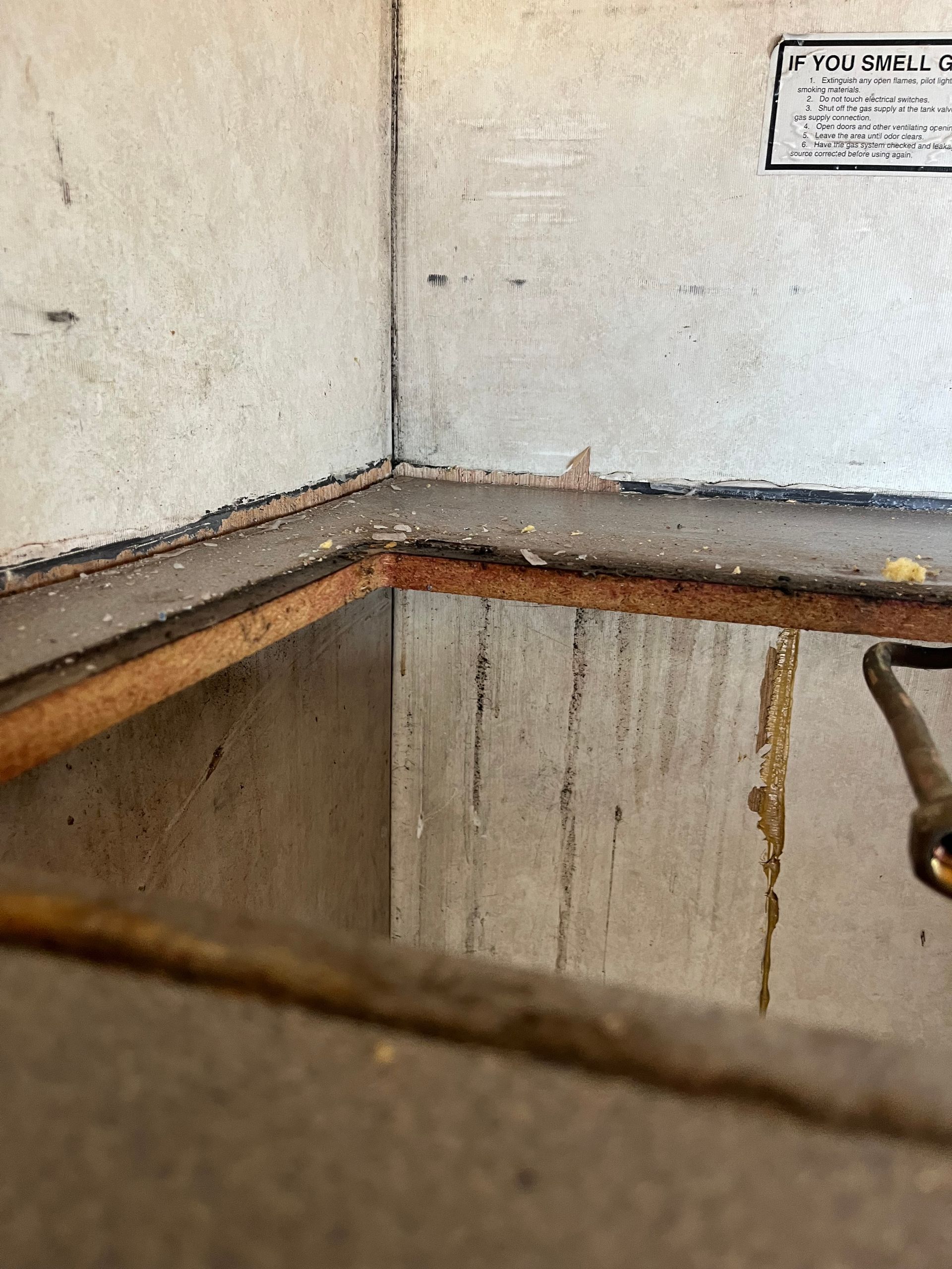 Inside a white-walled compartment. A wood frame is visible at the bottom.
