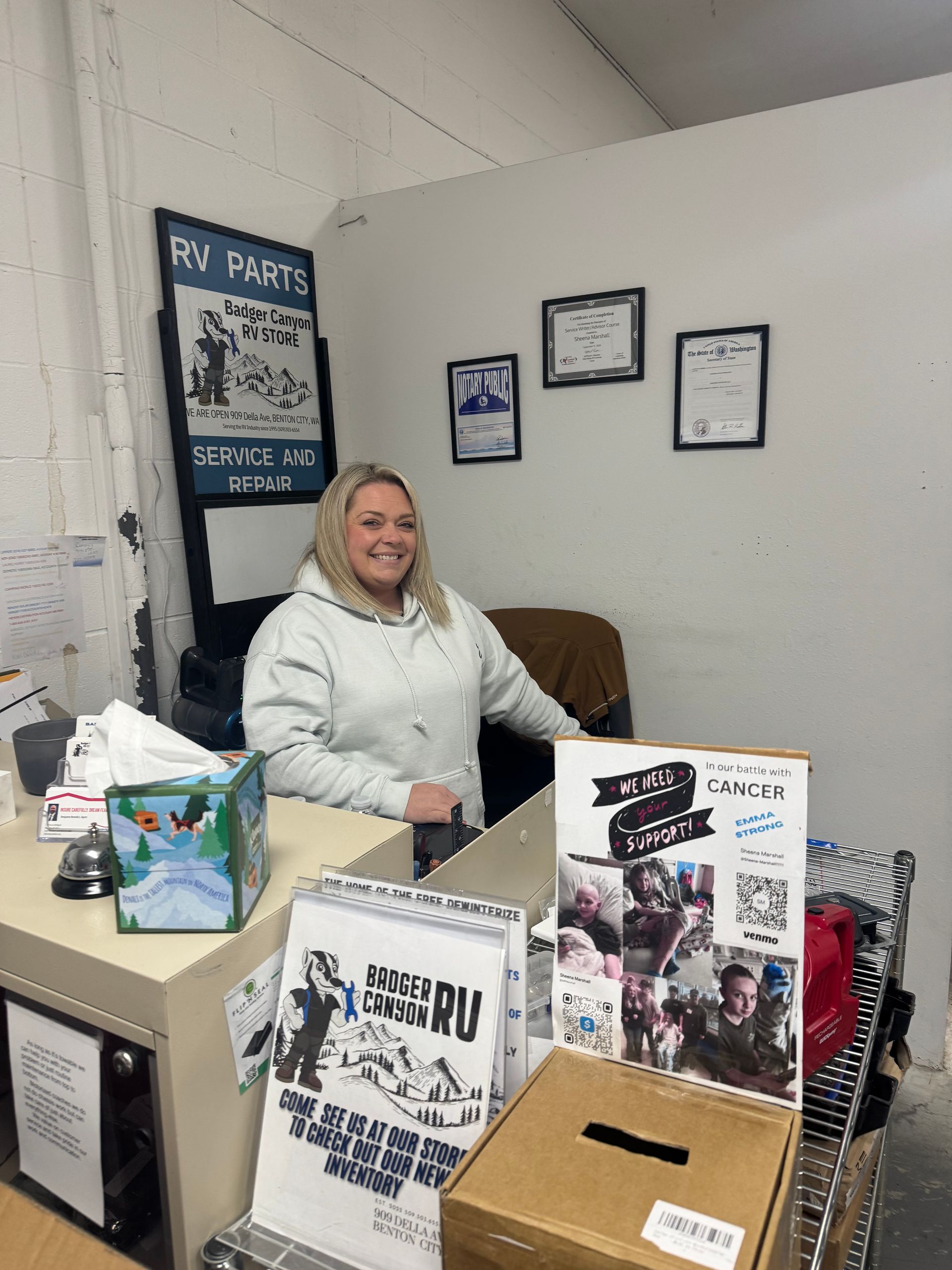 Woman smiling behind a desk with 