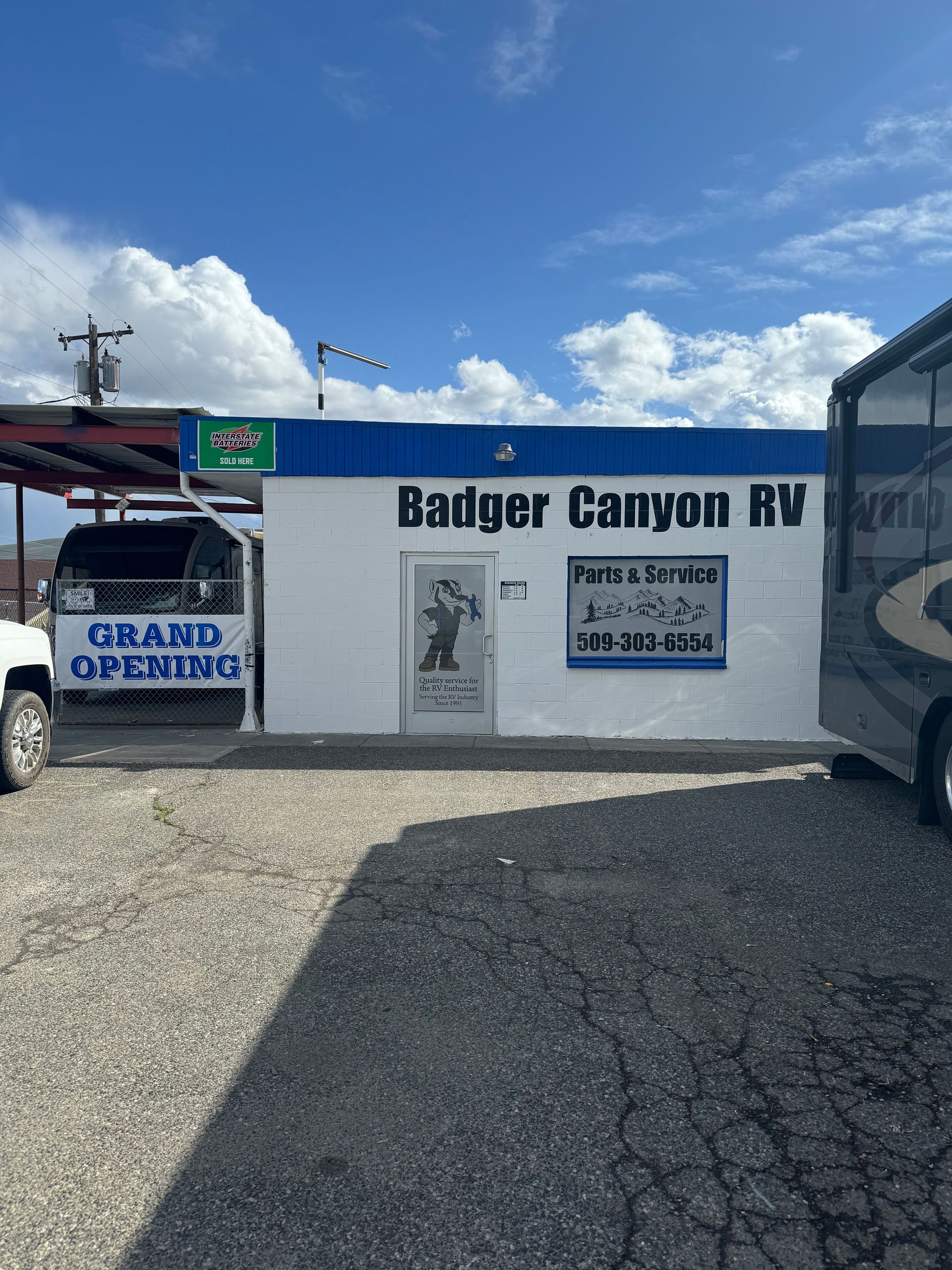 Badger Canyon RV business with a white building and blue trim, holding a grand opening.