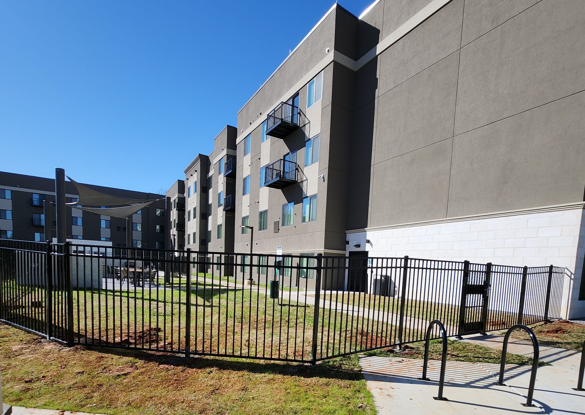 A fenced in area with a building in the background