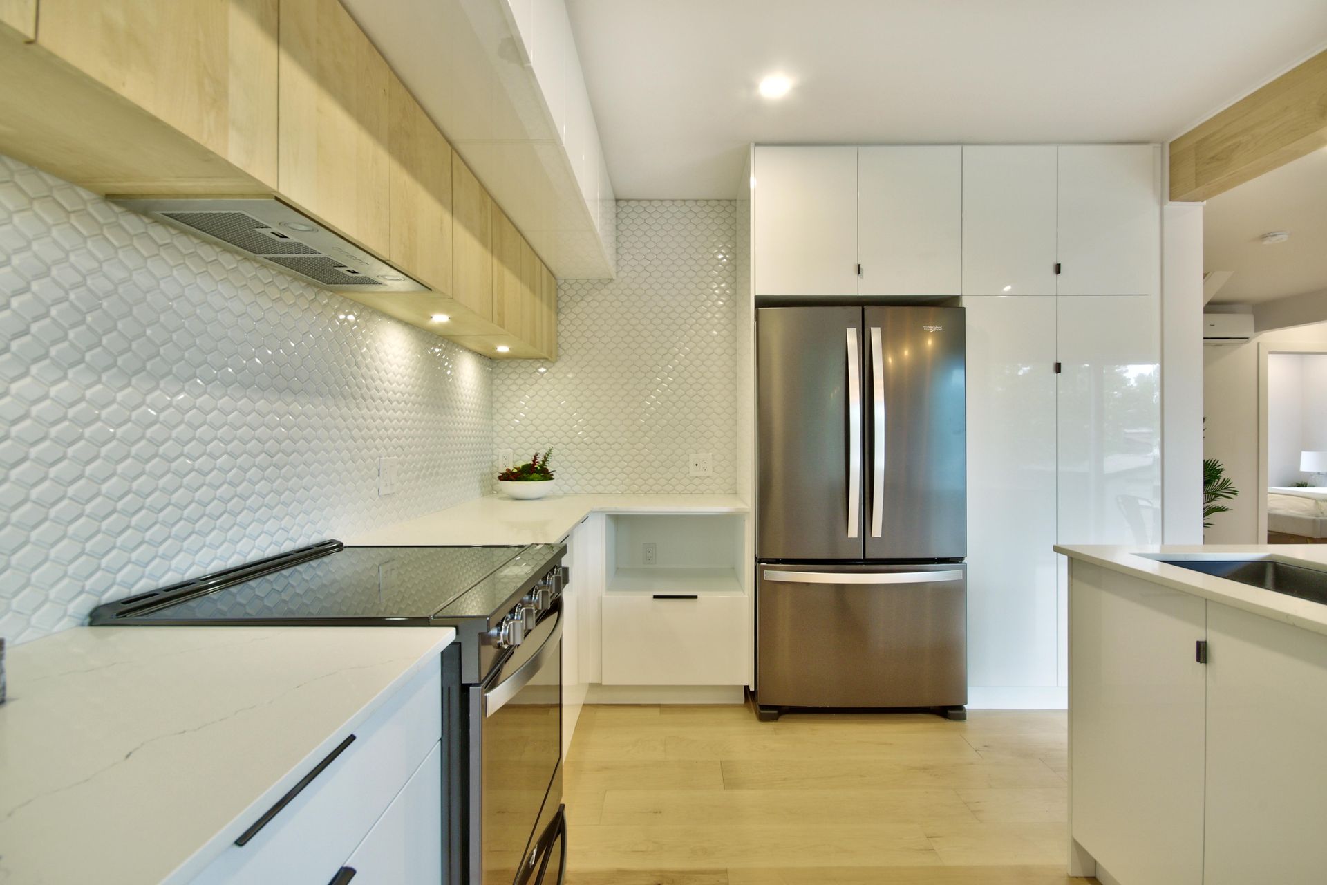 A kitchen with stainless steel appliances and white cabinets