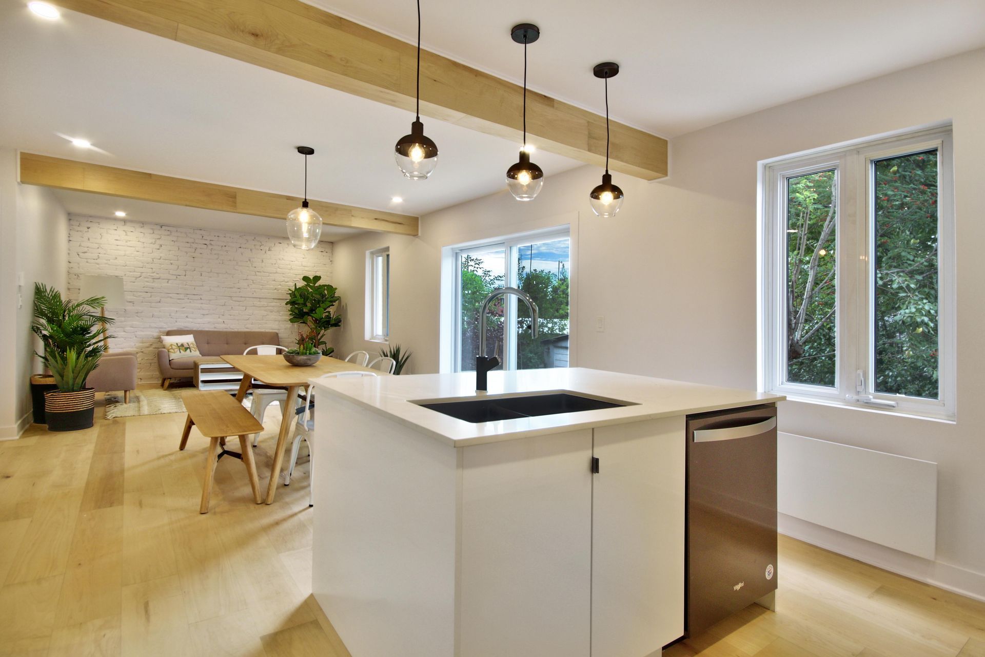 A kitchen with a large island , sink , and dishwasher.
