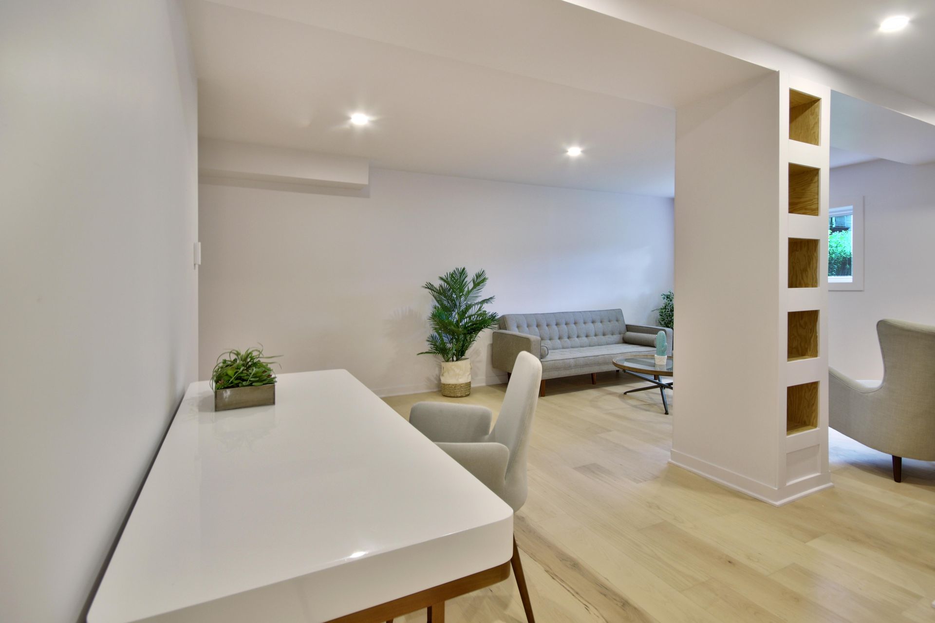 There is a desk and chair in the middle of the room.