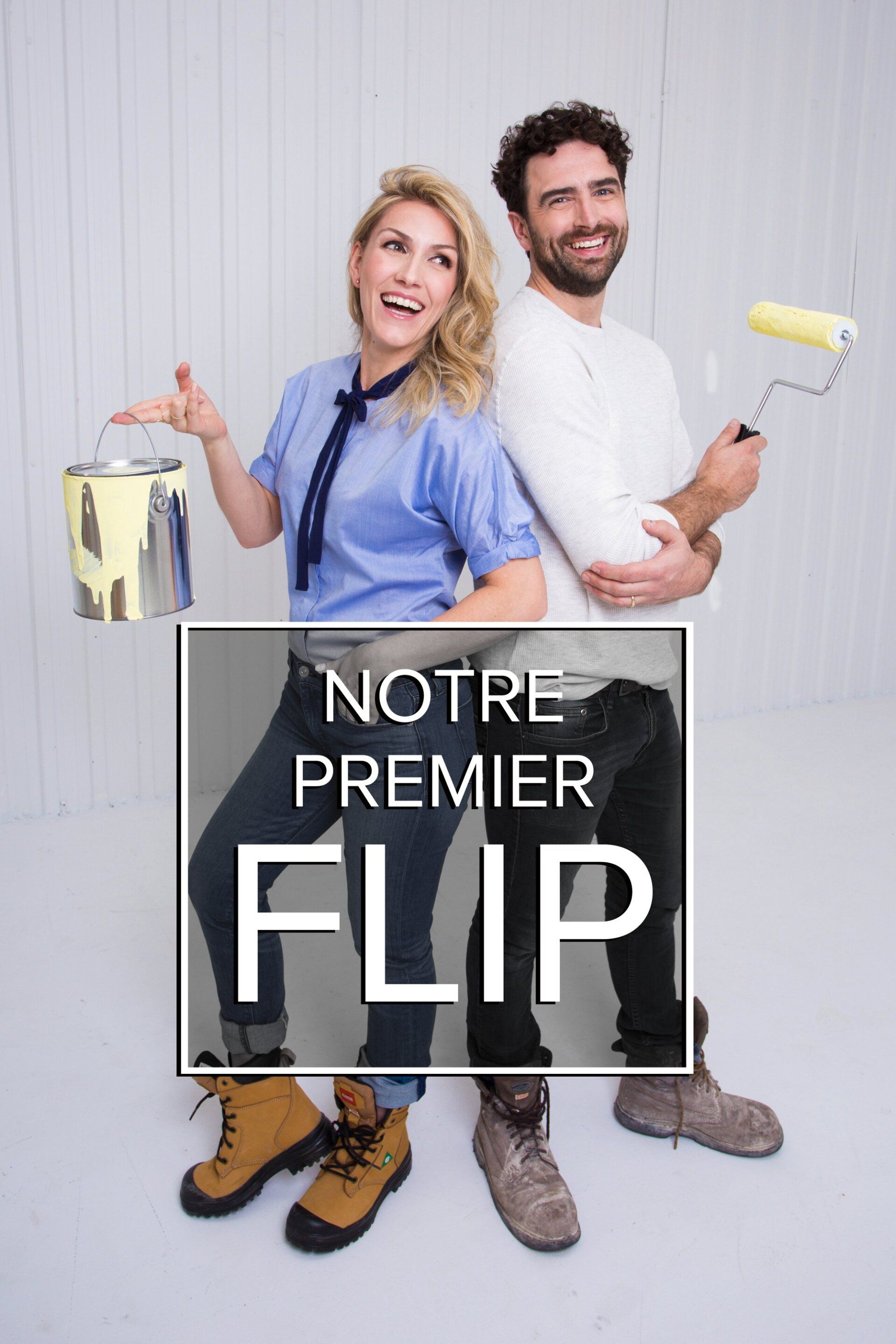 A man and a woman are standing next to each other holding paint rollers.