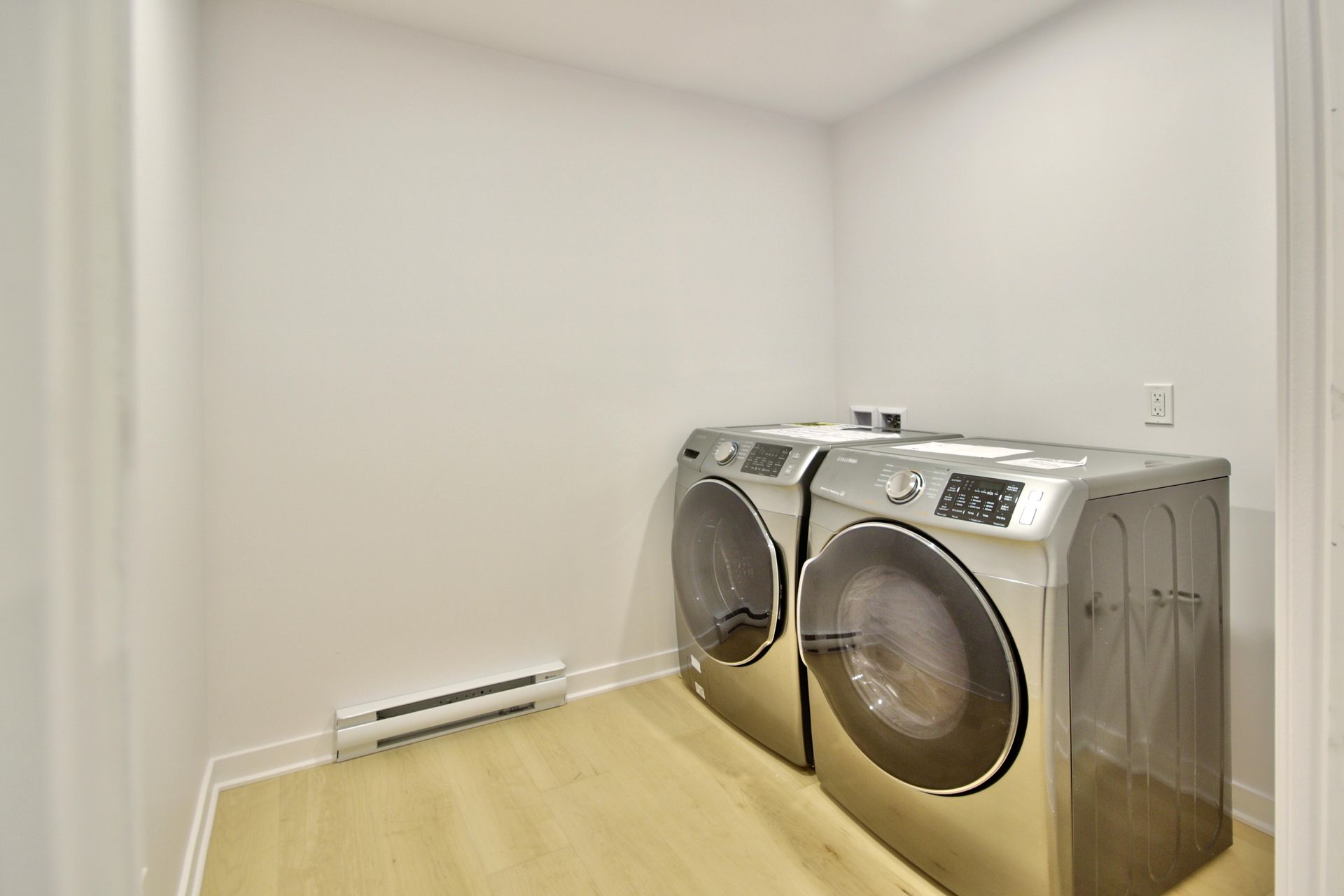 A laundry room with a washer and dryer in it