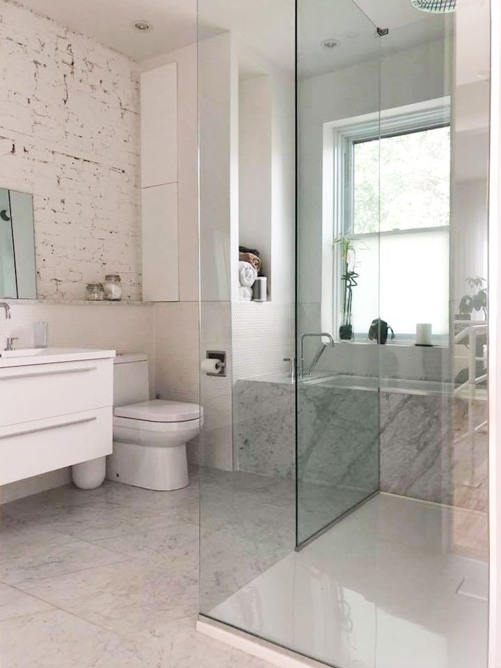A bathroom with a toilet , sink , and walk in shower.