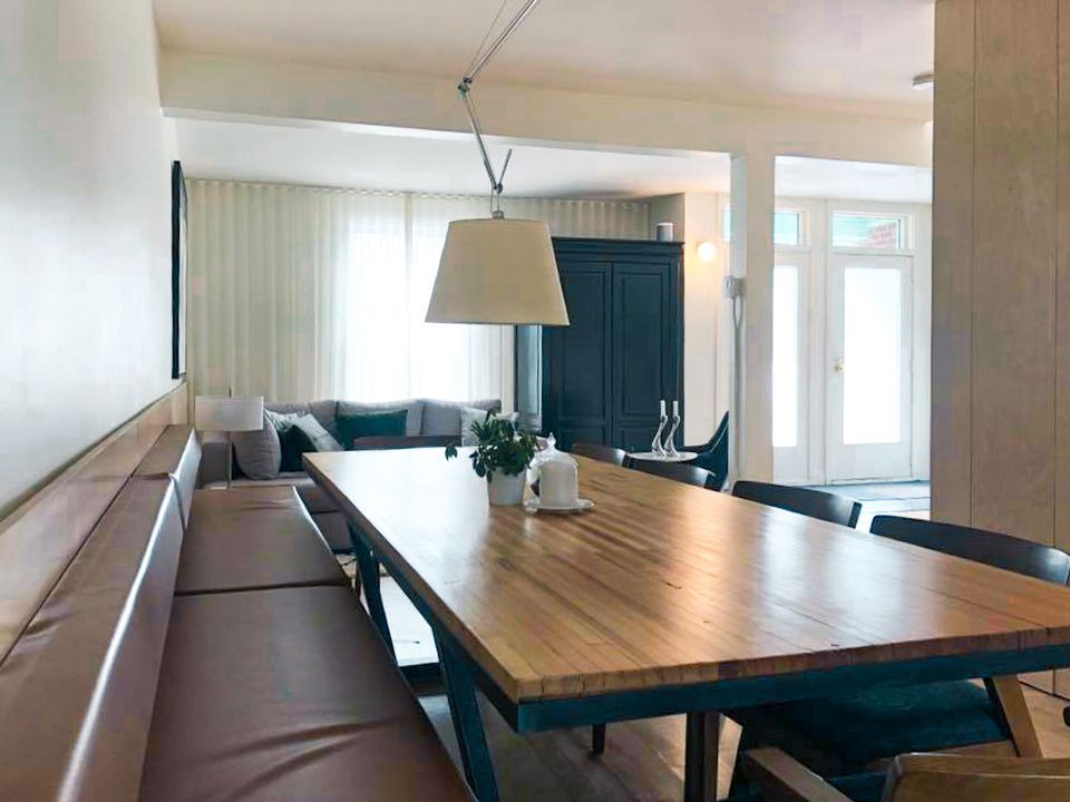 There is a long wooden table in the middle of the room.