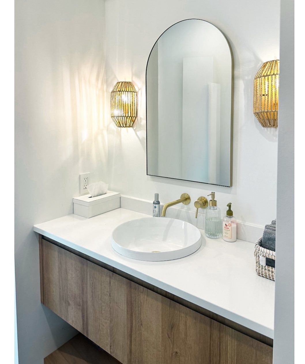 A bathroom with a sink and a mirror on the wall