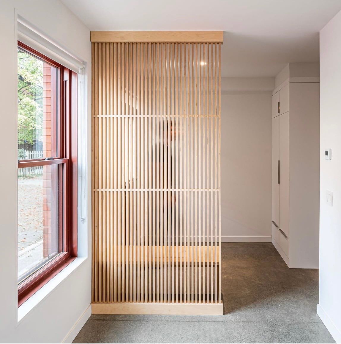 A room with a wooden divider and a window
