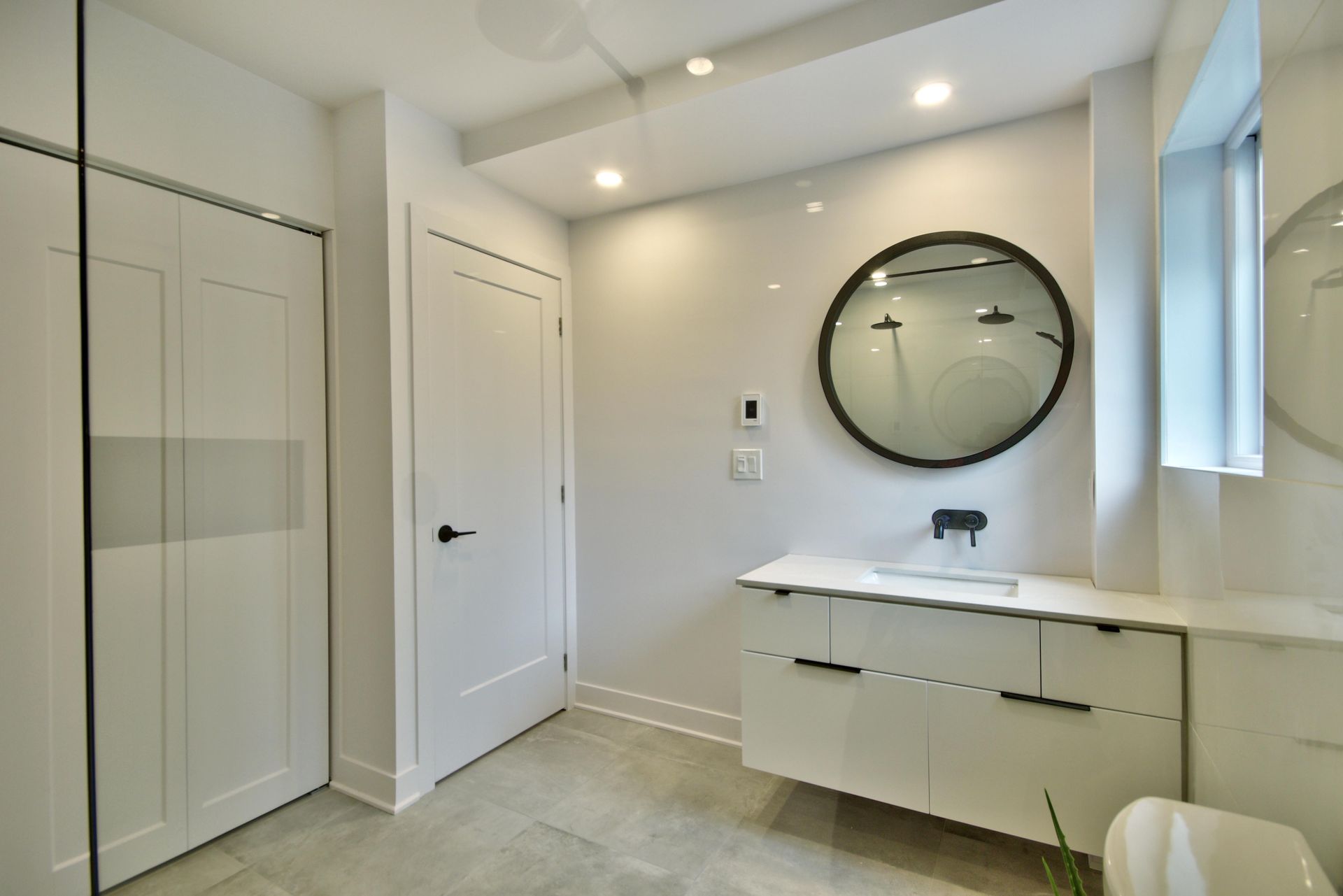 A bathroom with a sink , toilet and mirror.