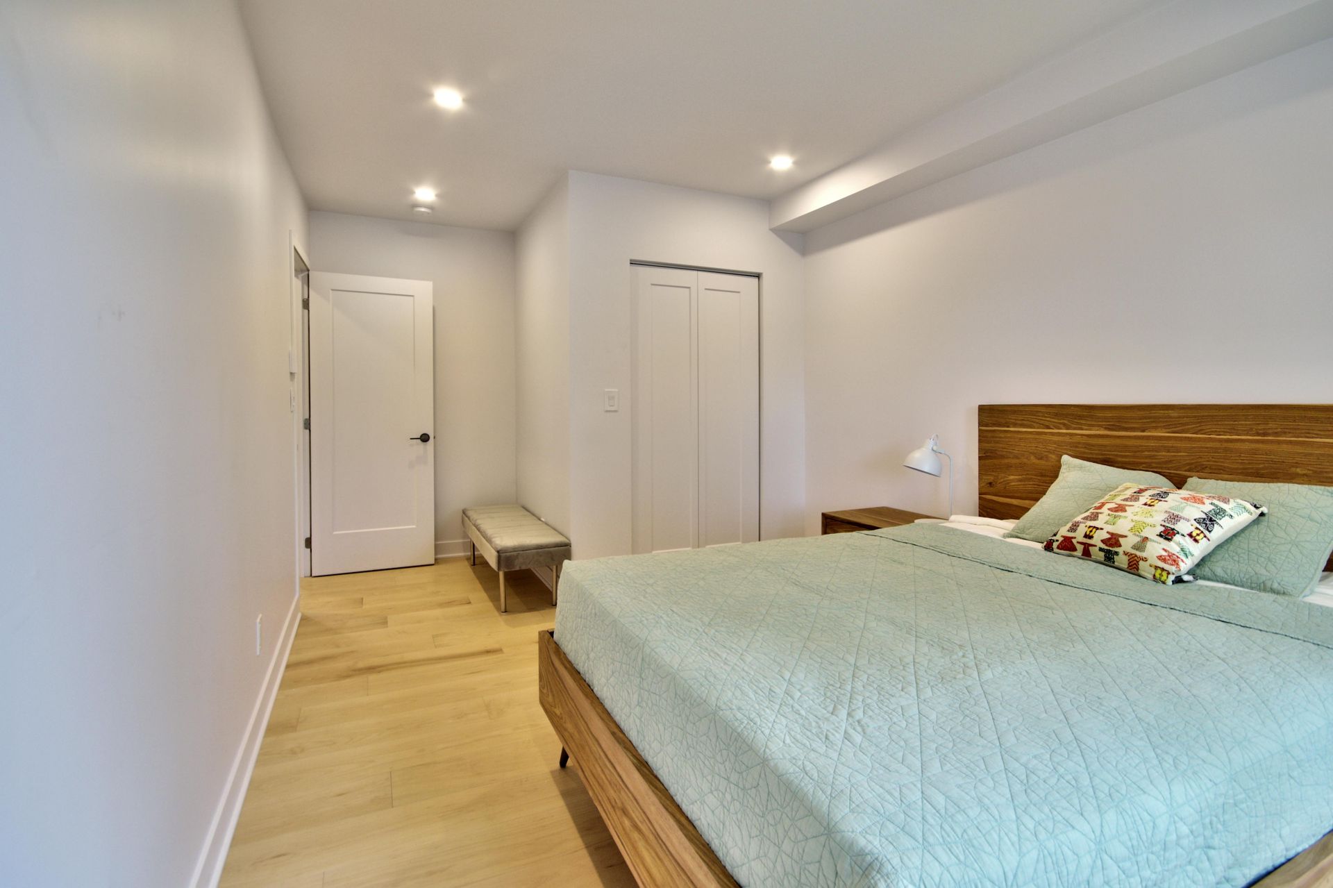 A bedroom with a king size bed and a wooden headboard.