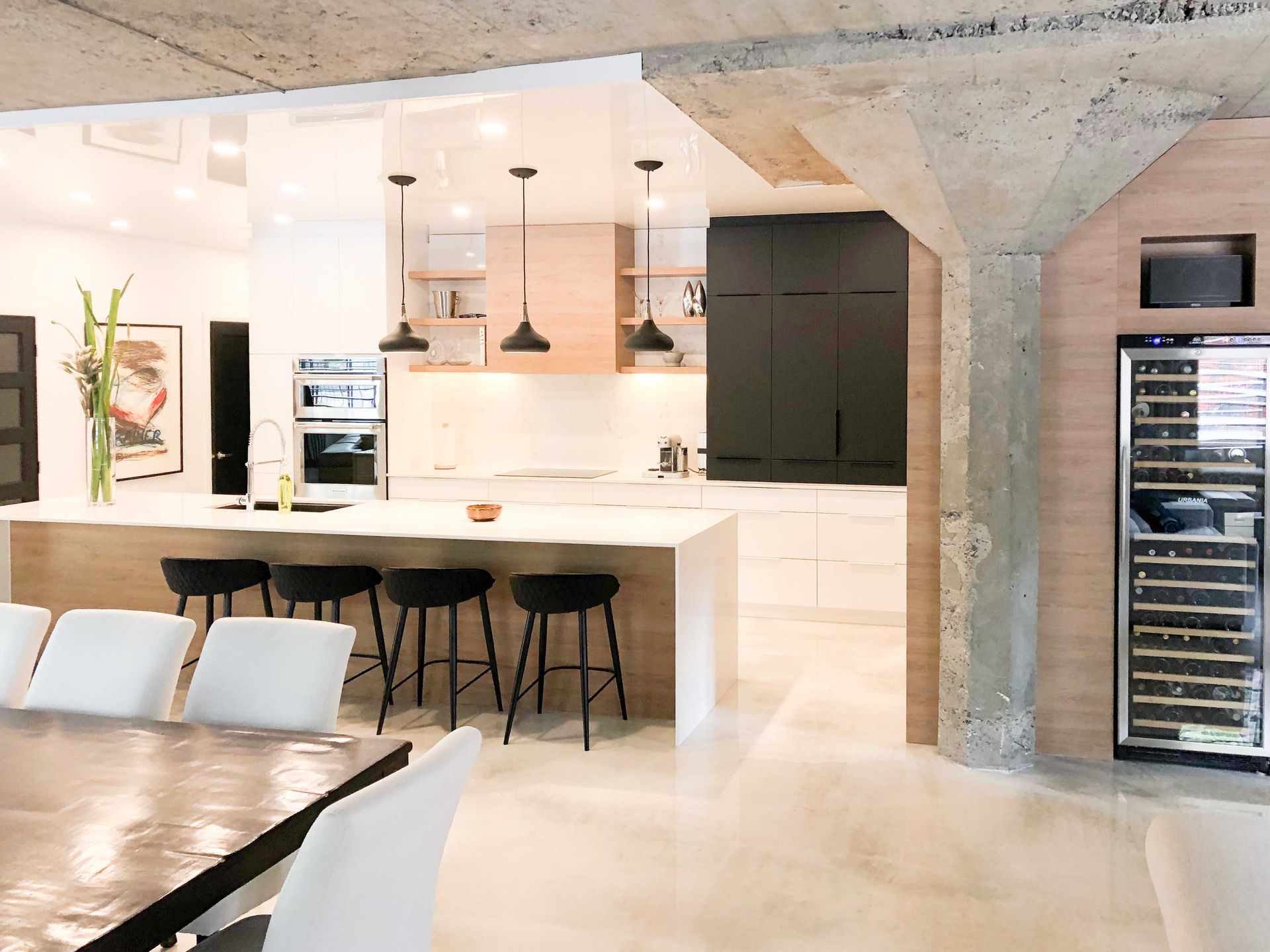 A kitchen with a table and chairs and a wine cooler