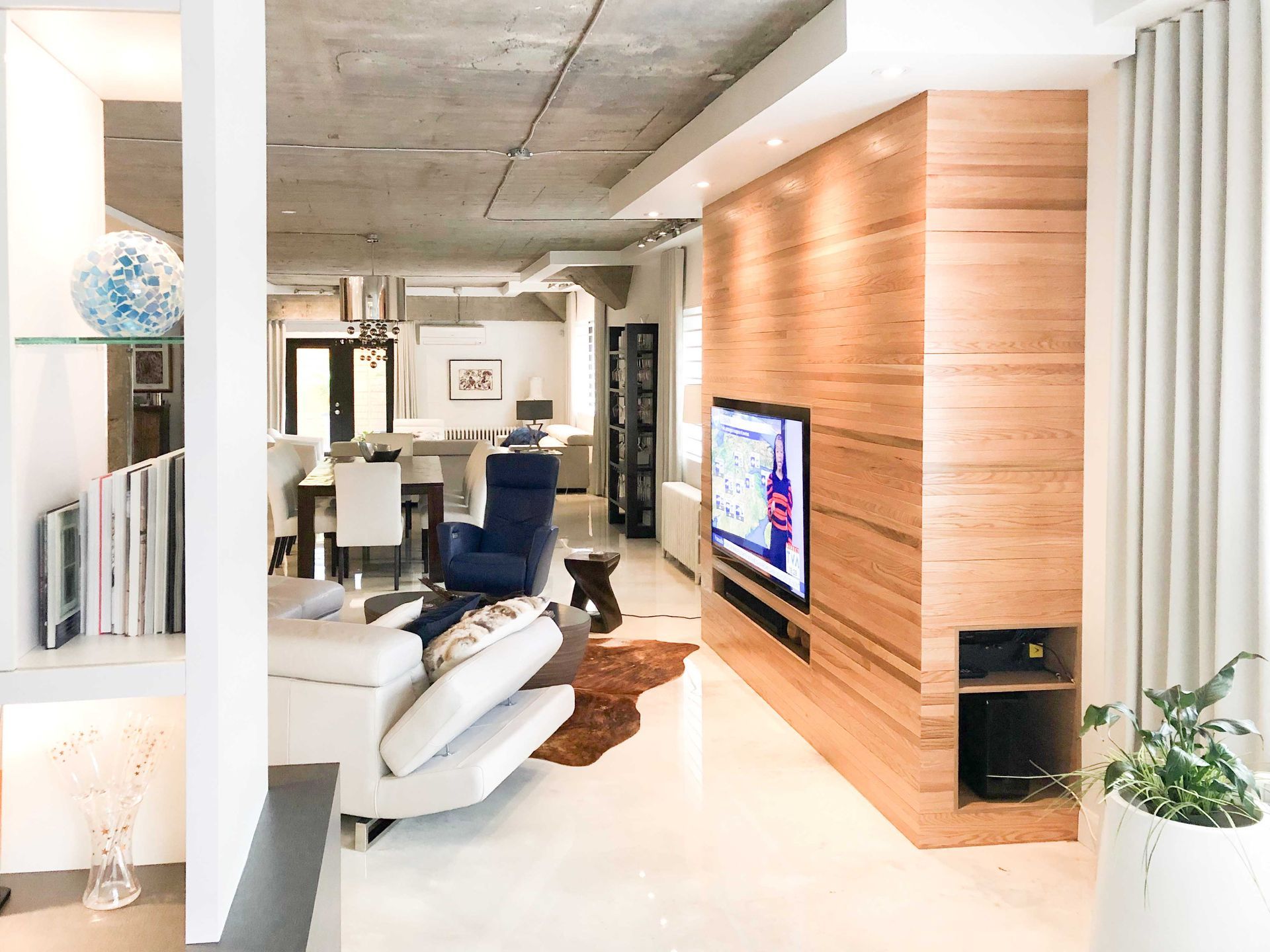A living room with a large flat screen tv on the wall