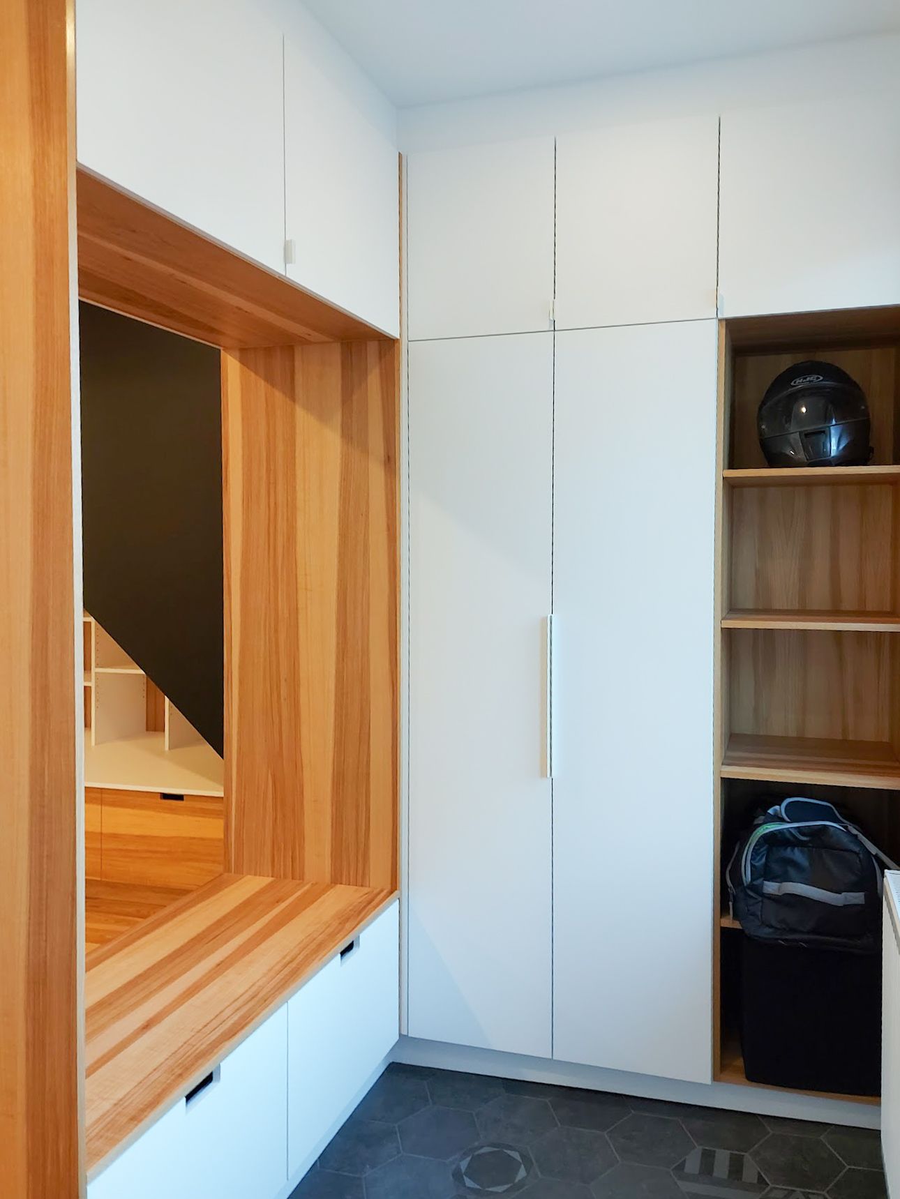 A room with white cabinets and a wooden window