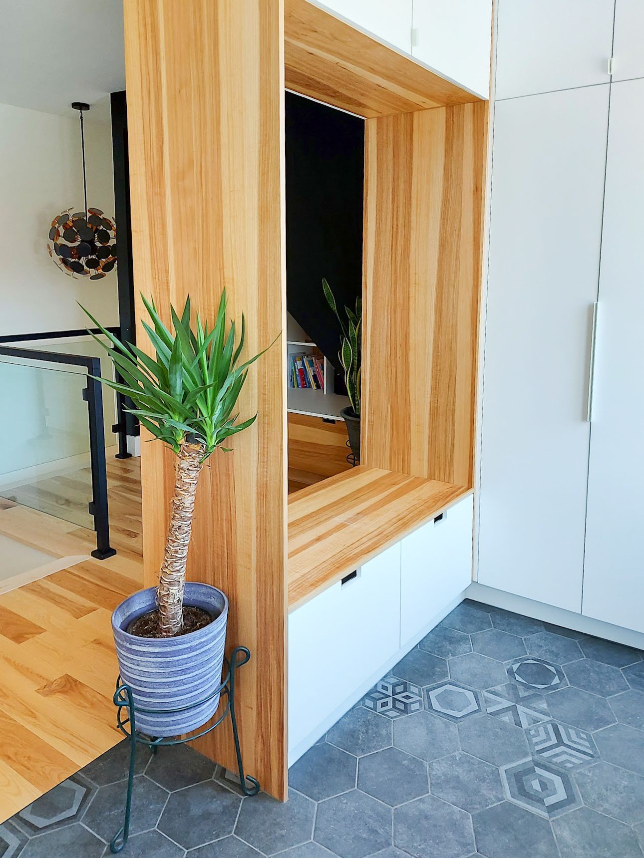 A potted plant is sitting next to a wooden wall in a room.