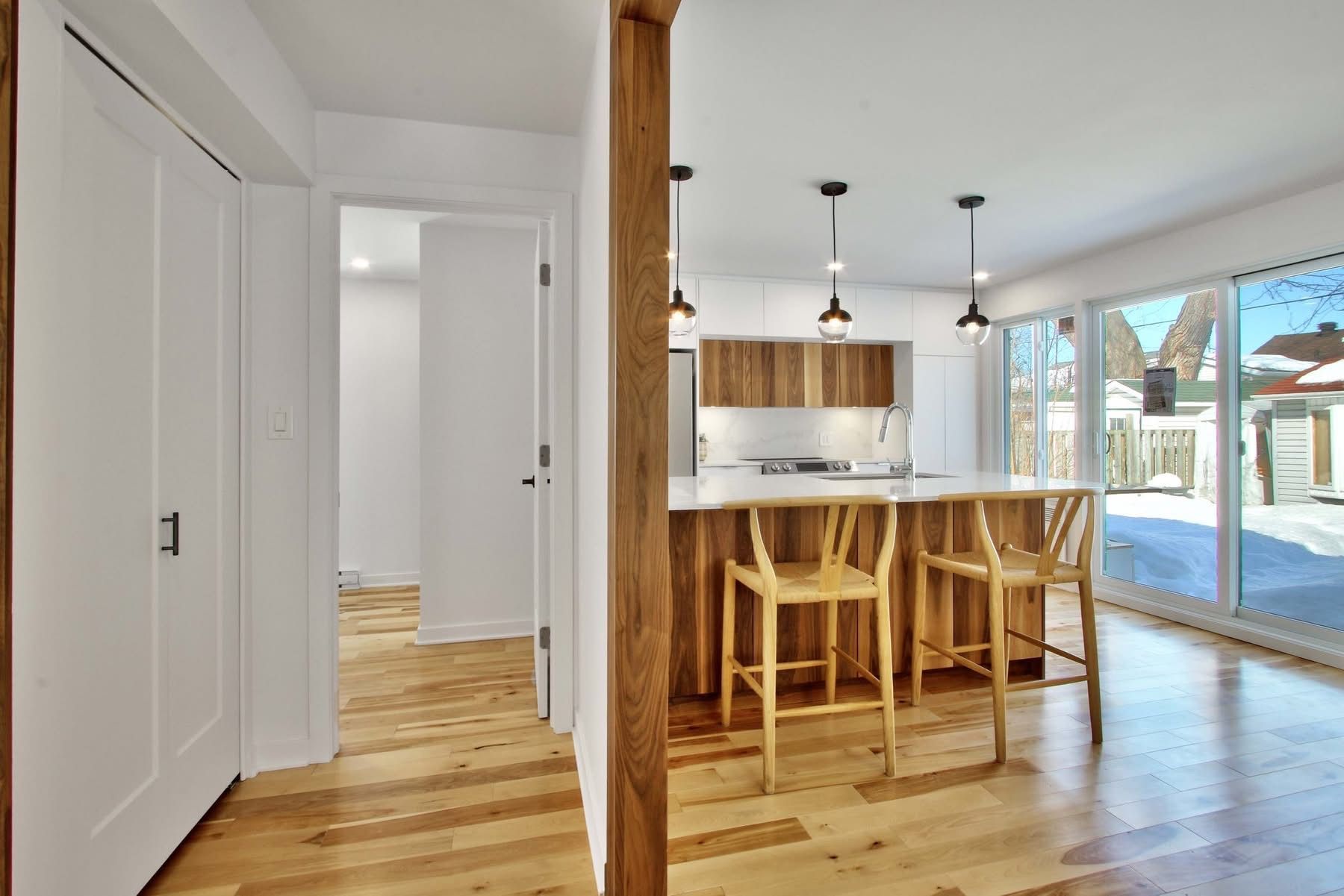 A kitchen with a wooden island and stools