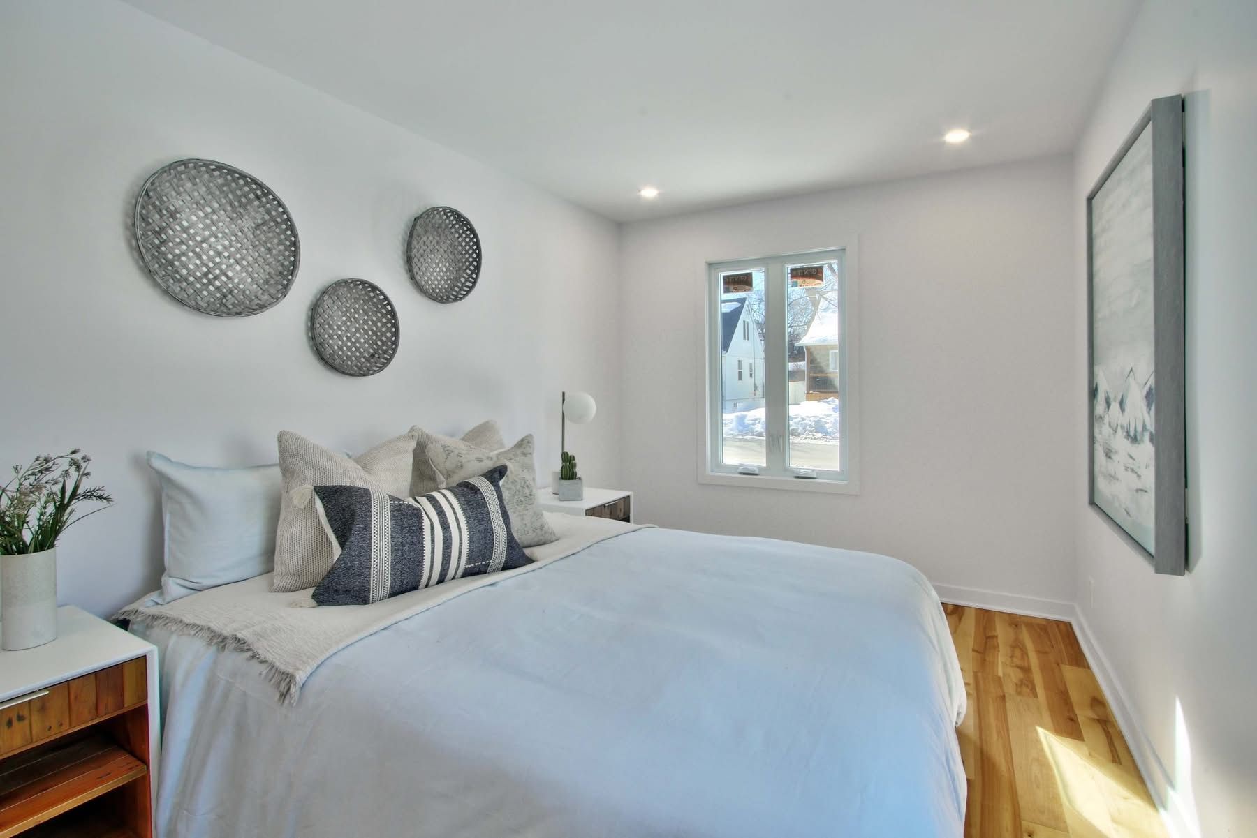 A bedroom with a large bed and a window.