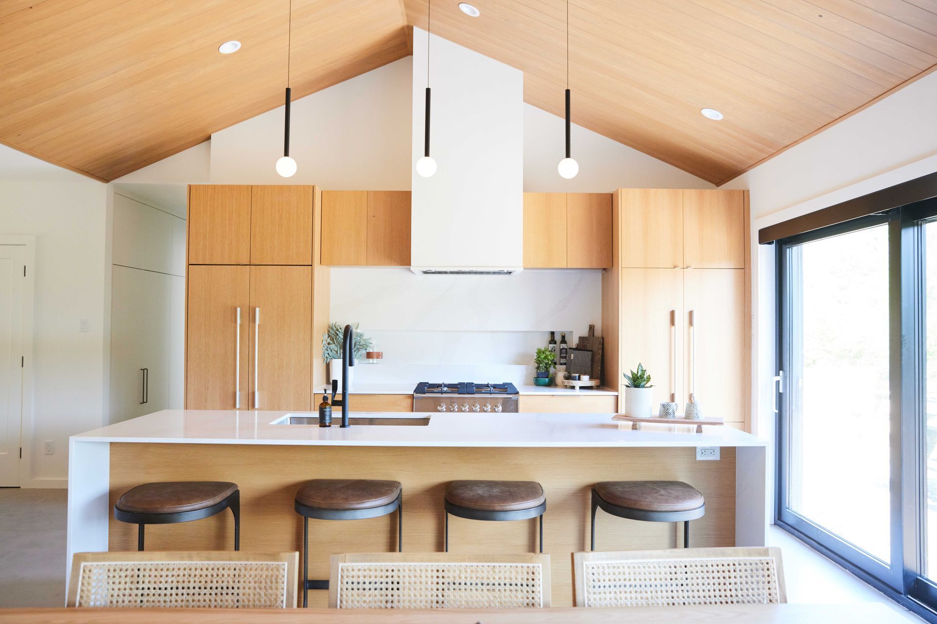 A kitchen with a vaulted ceiling and wooden cabinets