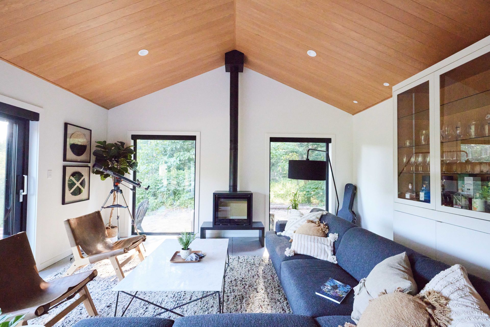 A living room with a couch , chairs , and a fireplace.