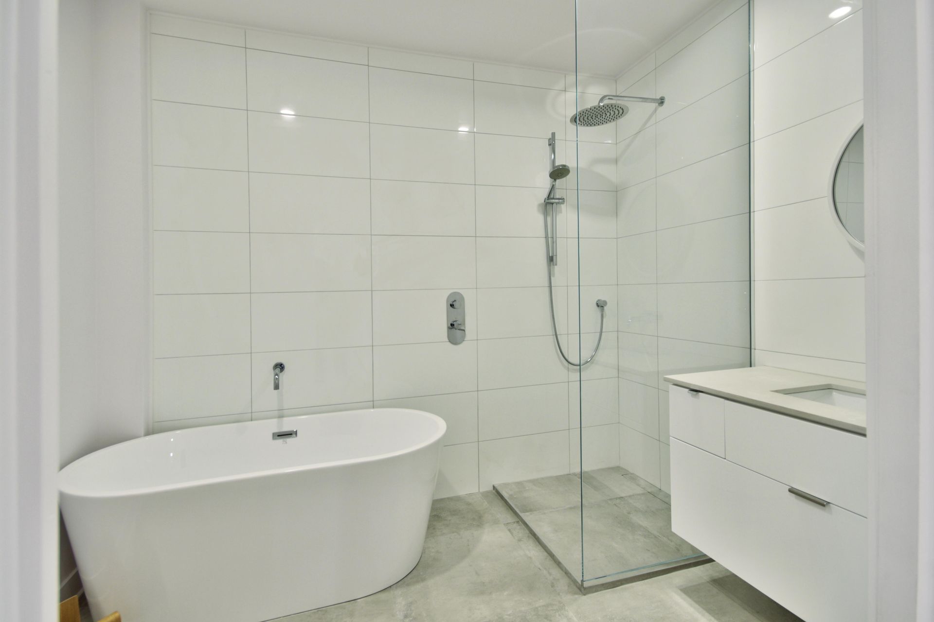 A bathroom with a bathtub and a walk in shower.