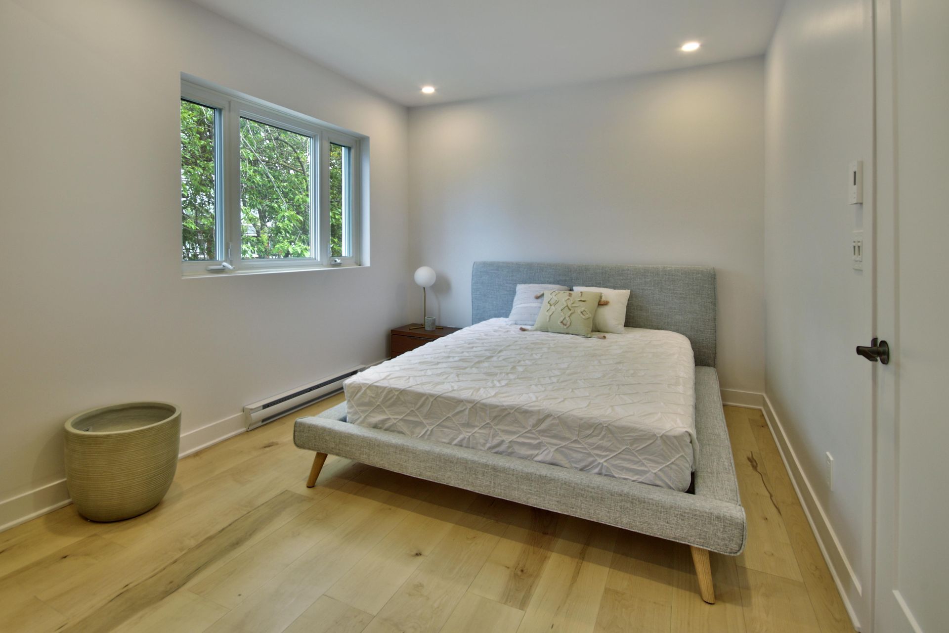 A bedroom with a large bed and a window