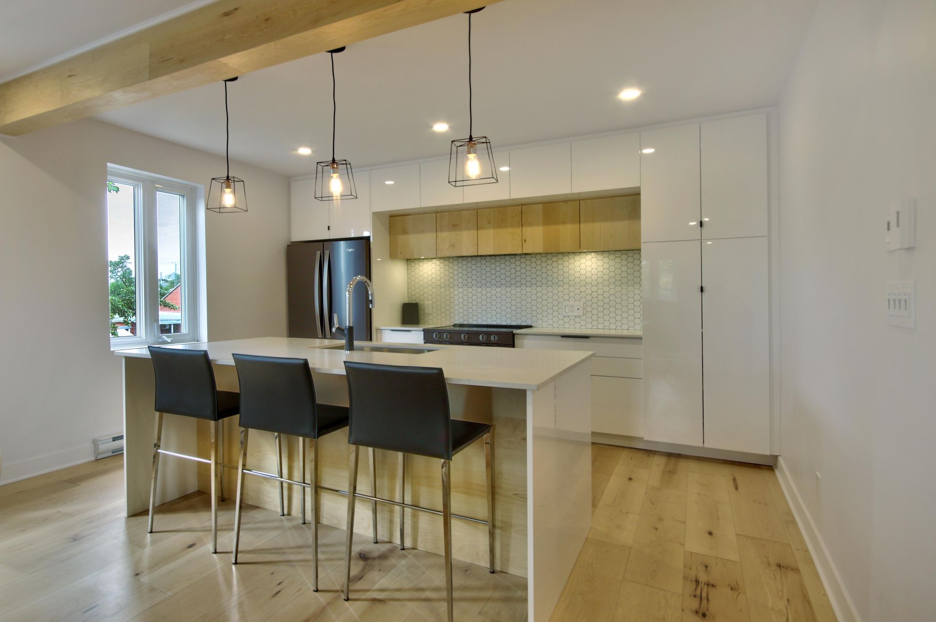 A kitchen with a large island and stools