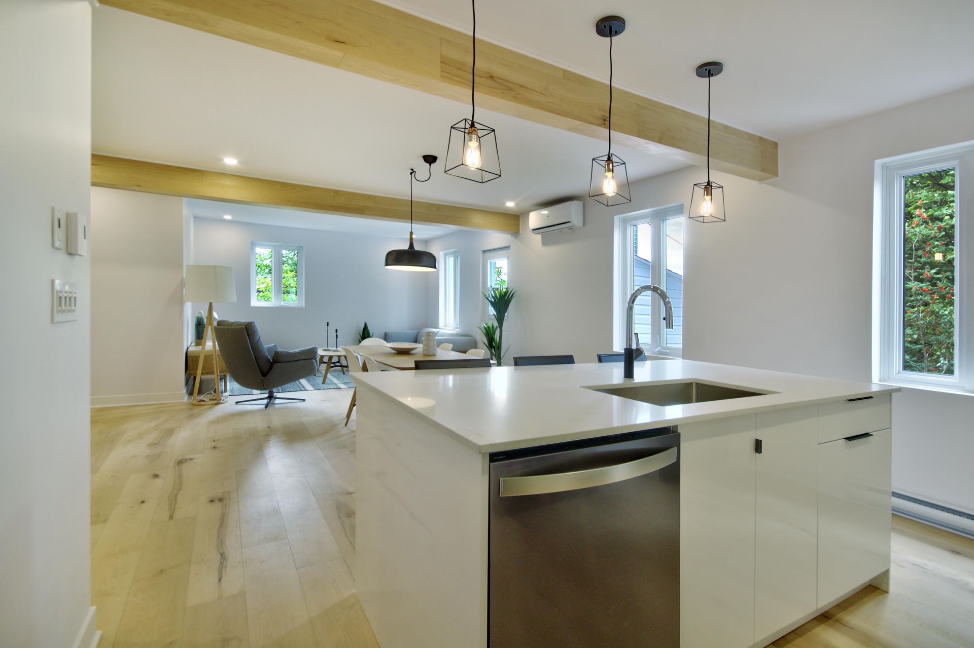 A kitchen with a large island , sink , and dishwasher.