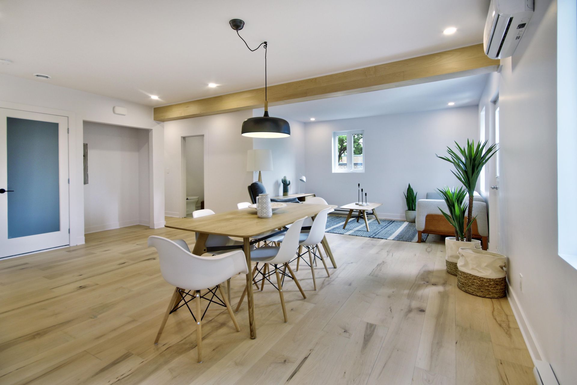 There is a table and chairs in the middle of the room.