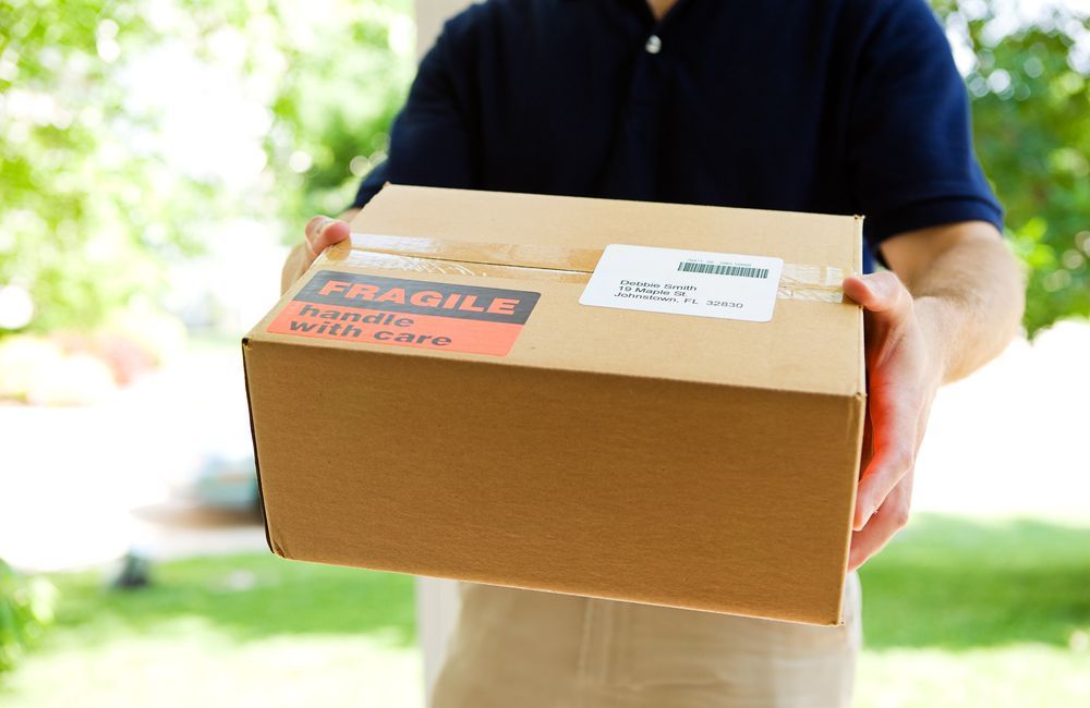 Person Holding a Cardboard Package — The Move It Man In Bentley Park, QLD