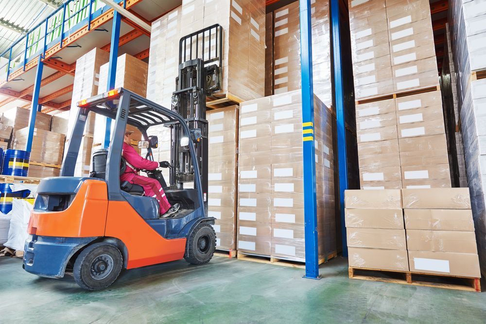Forklift Operating in a Warehouse Person Driving Lifts Boxes on a Pallet — The Move It Man In Mission Beach, QLD
